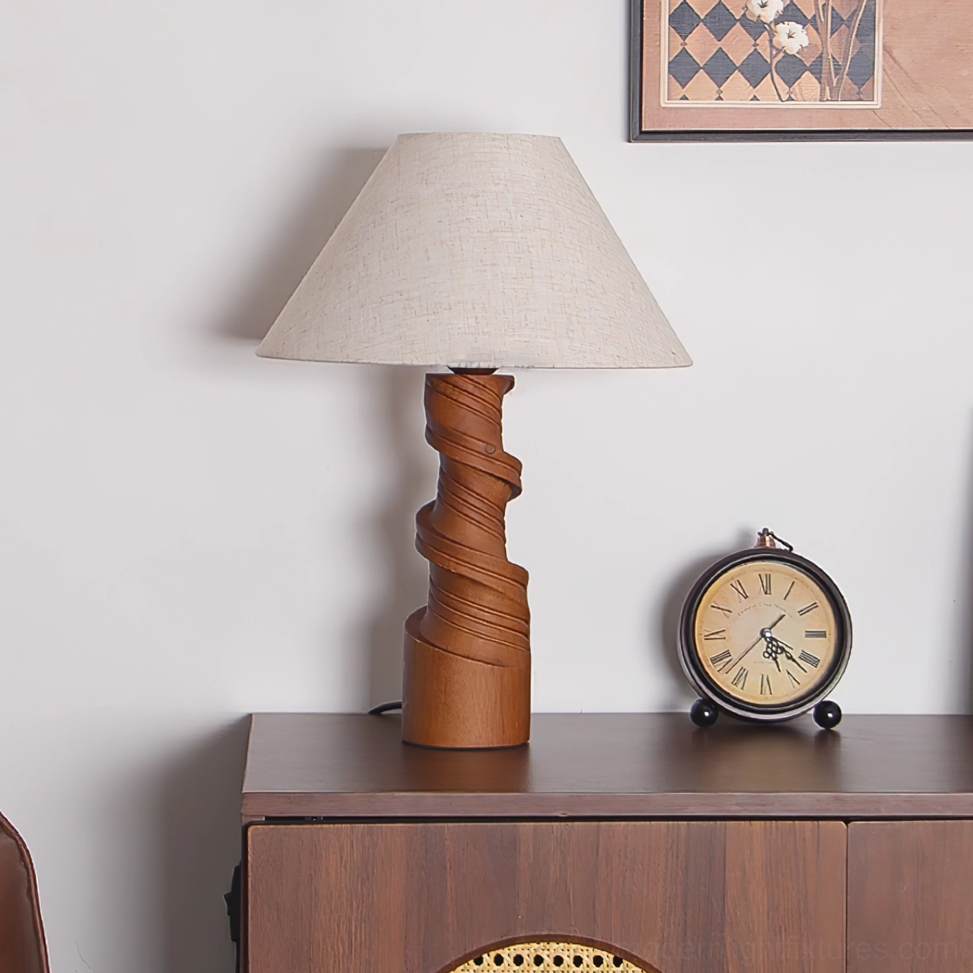 Scrollroot table lamp on living room cabinet with plain linen shade, twisted wood base, clock decor styling