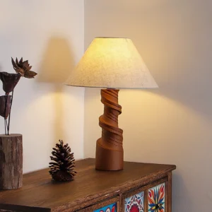 Illuminated scrollroot table lamp displayed on cabinet with bohemian decor, linen shade glowing warmly