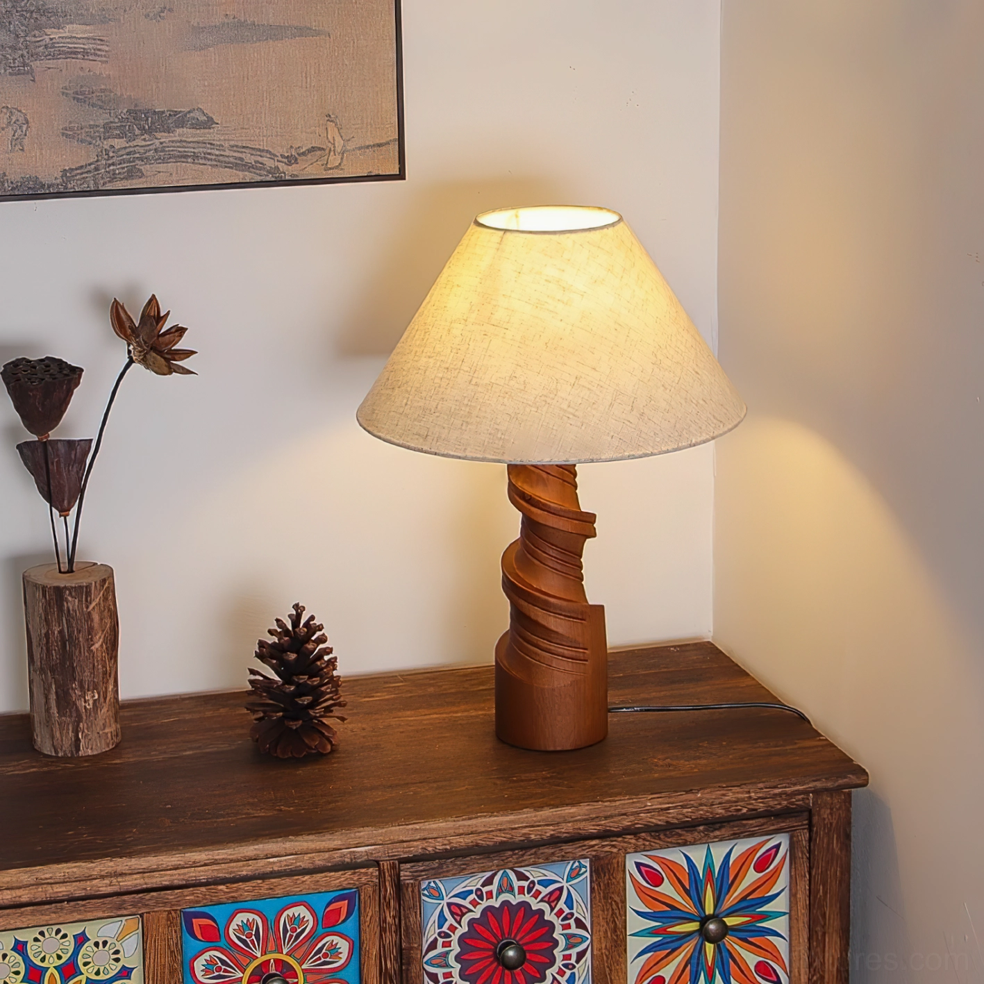 Scrollroot table lamp illuminated on vintage cabinet with twisted wood base, dried flowers and pinecone styling