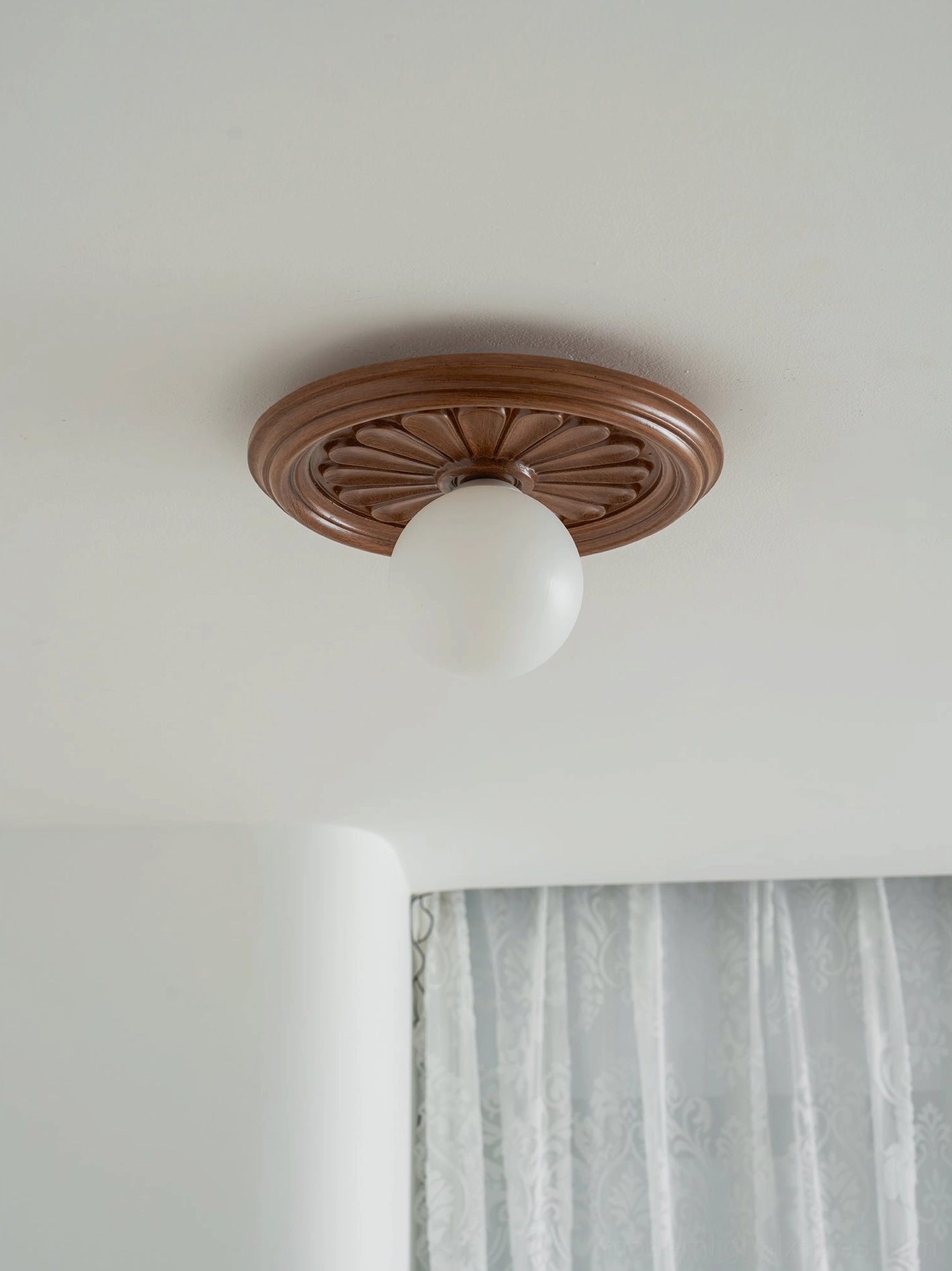 Modern carved resin ceiling light showing sculptural canopy as decorative object
