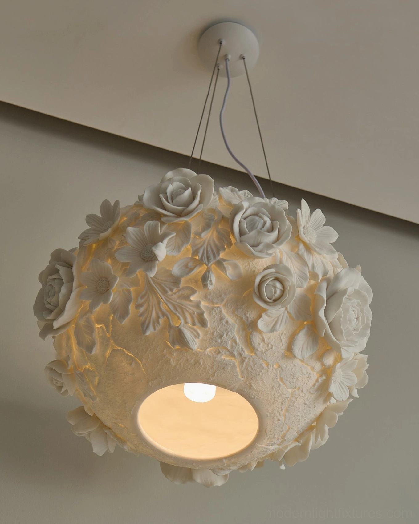 Sculptural ceramic floral pendant light showing dimensional flower arrangement and warm glow distribution throughout shade