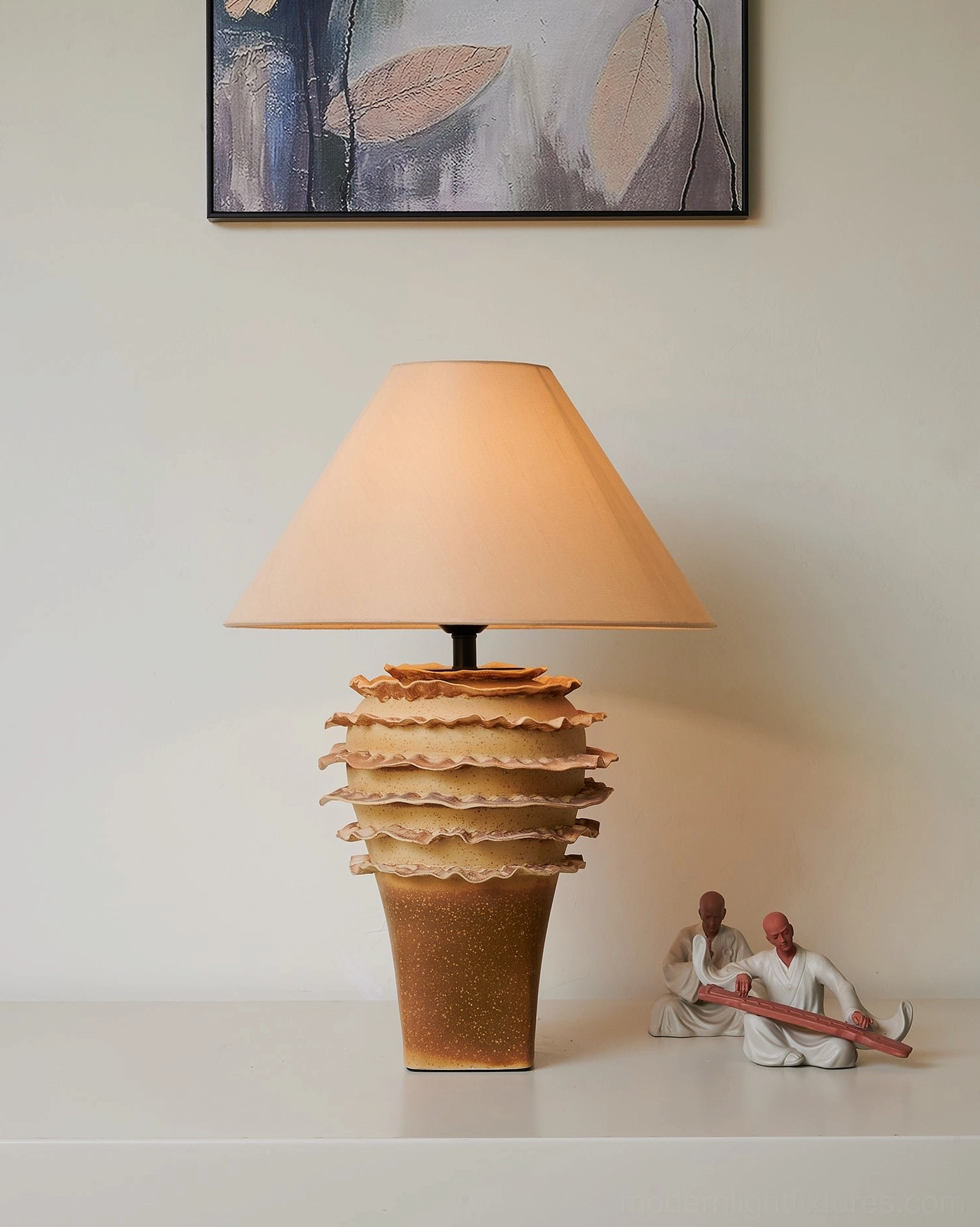 Sculptural ceramic table lamp with organic tiered construction in modern home decor setting