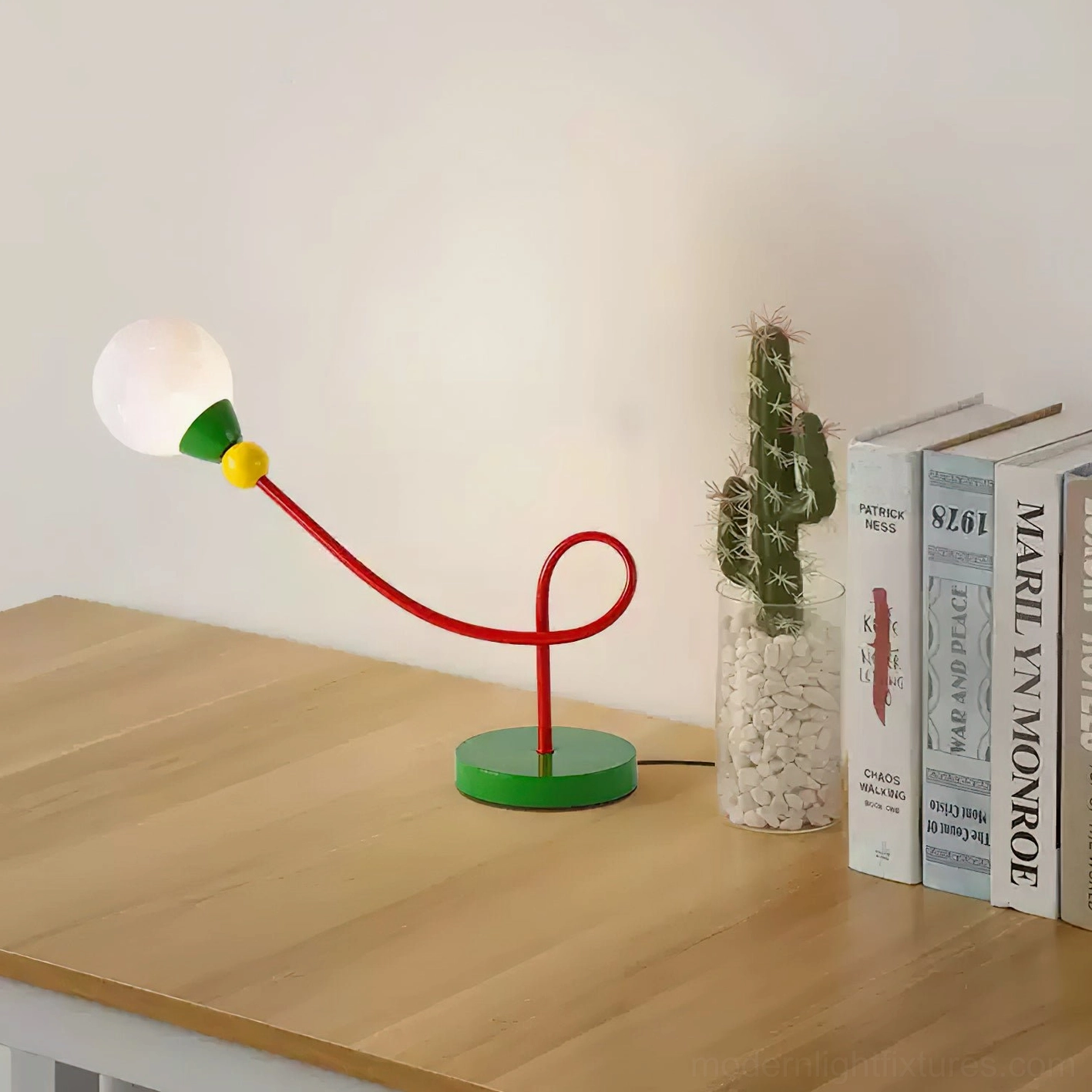 Modern sculptural table lamp with curved arm and vibrant color palette for artistic home decor
