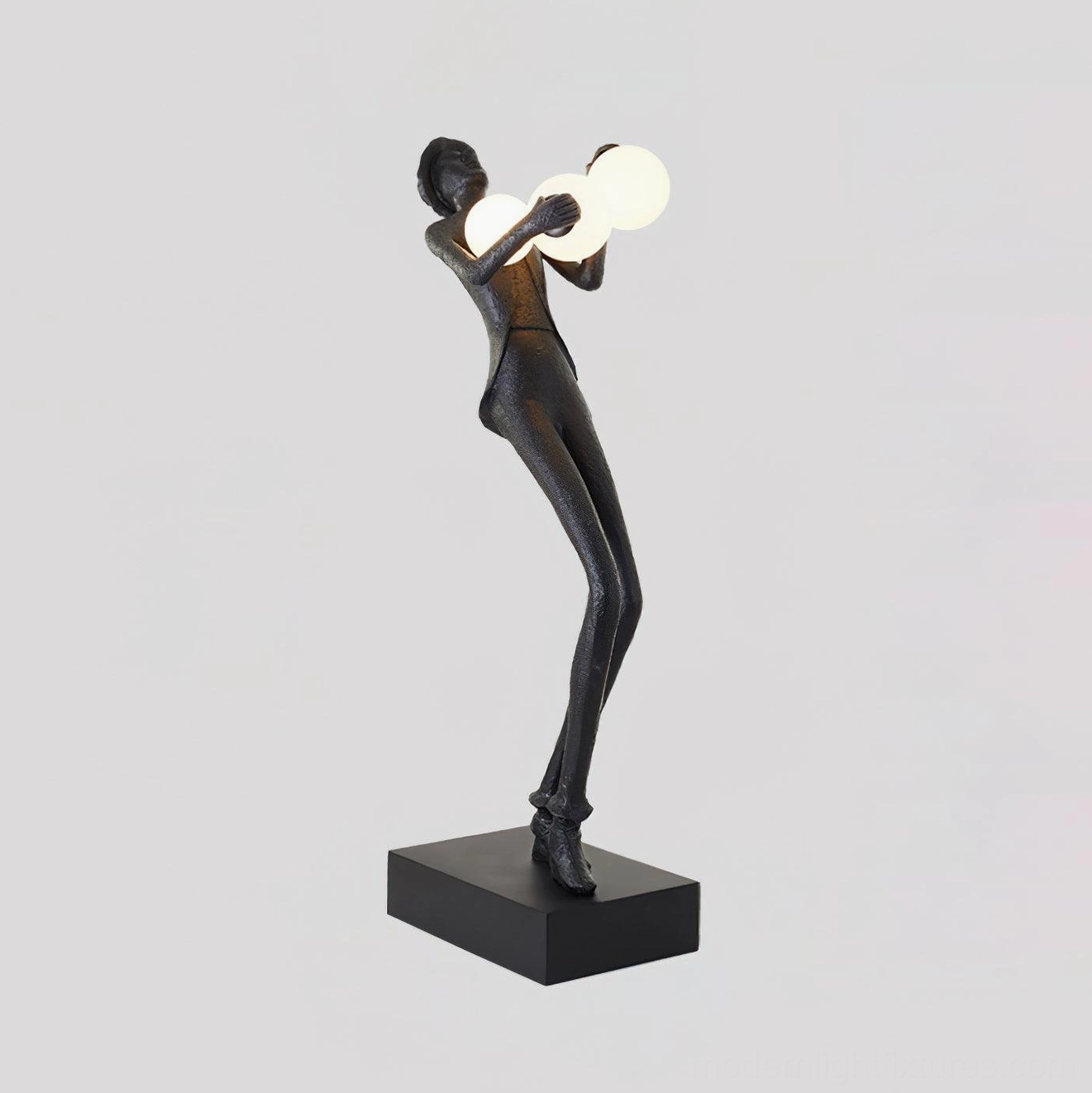 Humanoid sculptural floor lamp detail view showcasing textured resin body and frosted glass globe illumination design