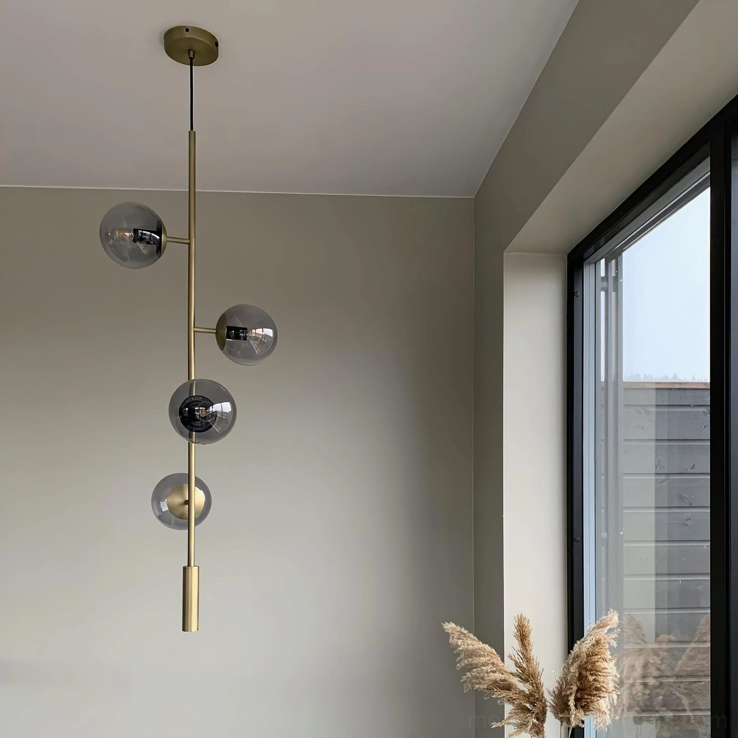 Sculptural glass orb chandelier creating artistic focal point in contemporary home