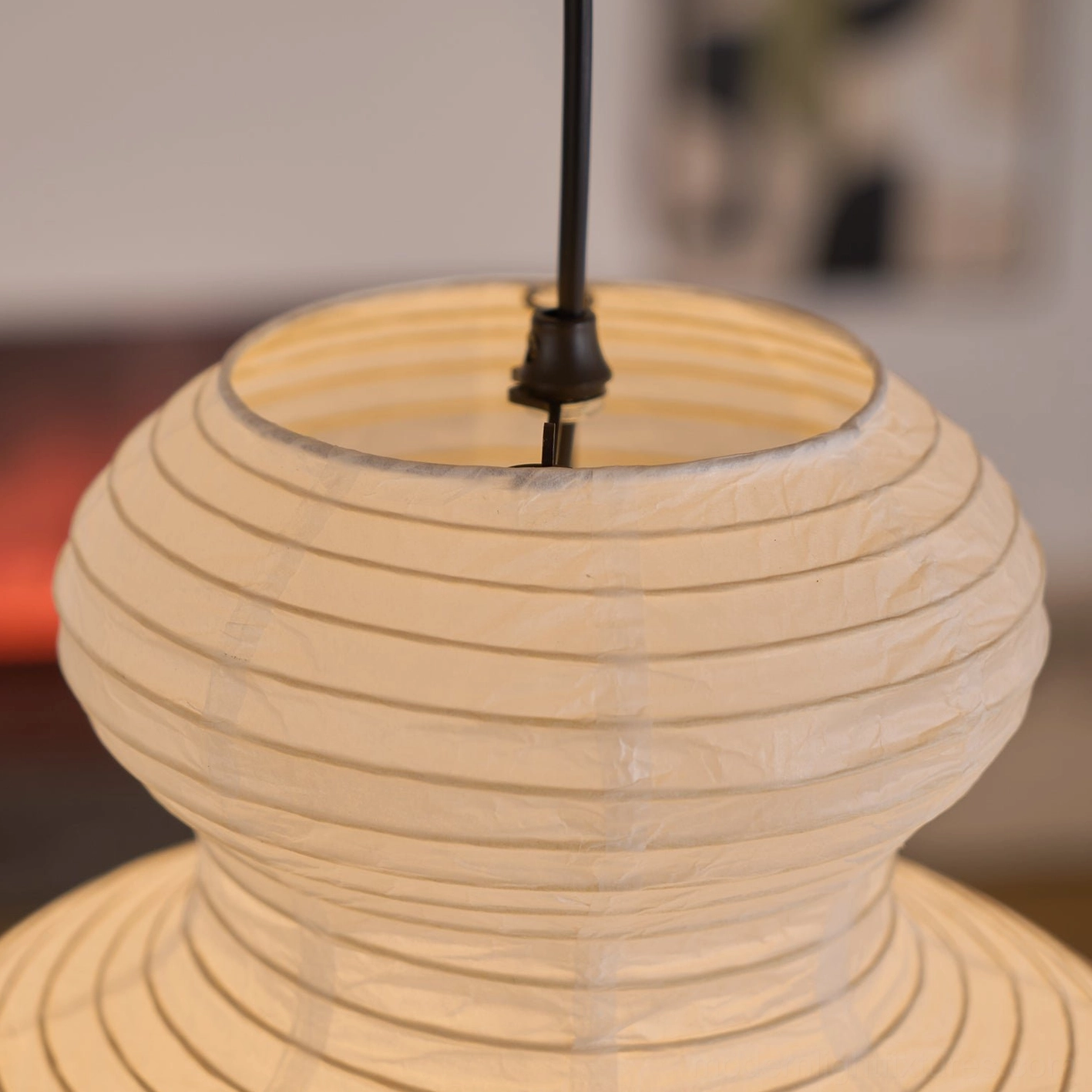 Sculptural pendant light paired with candlelight creating genuinely restorative evening atmosphere