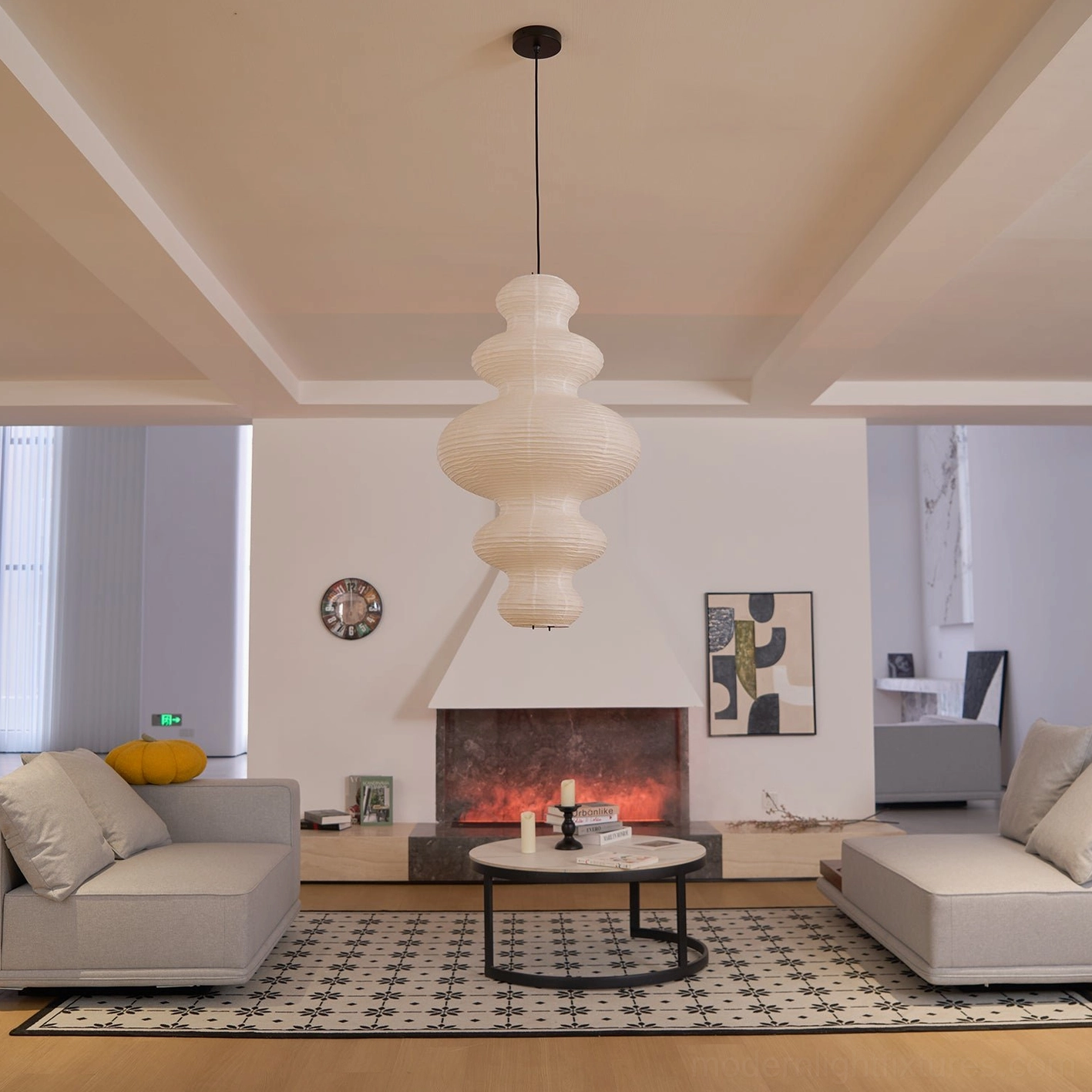 White sculptural pendant light in study corner providing soft focused task lighting and ambient glow