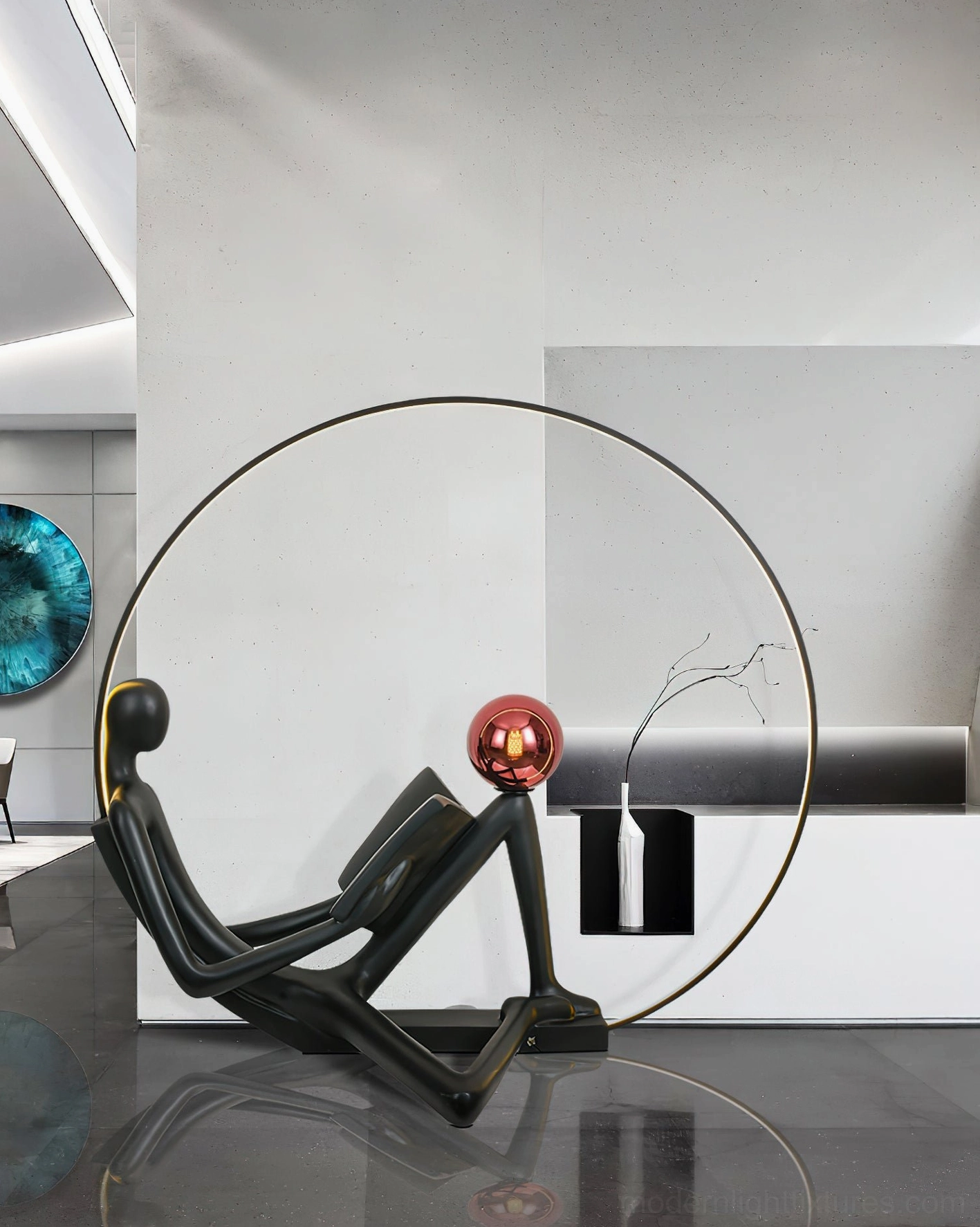 Modern black reading figure floor lamp with red sphere, minimalist entryway on low black platform with grey cabinet