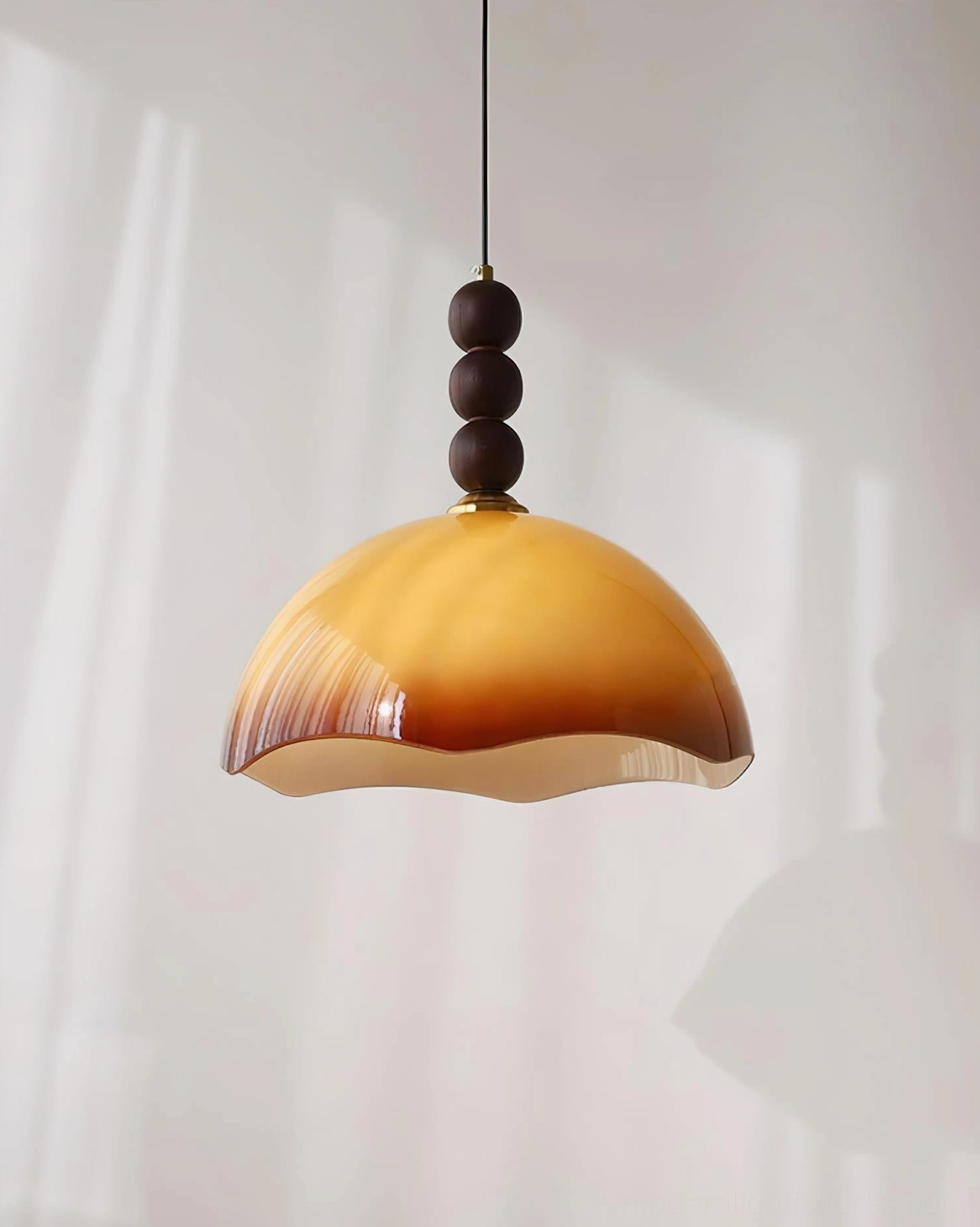Sculptural mid-century modern rippled pendant light suspended in minimalist contemporary residential interior