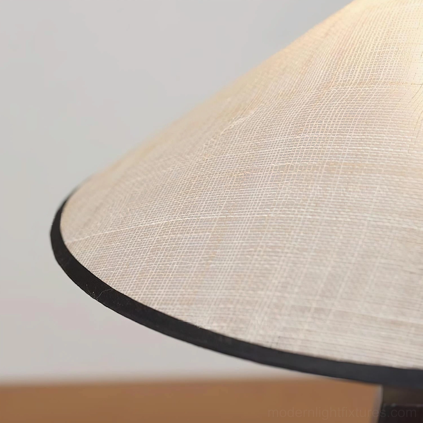 Sculptural minimalist wood table lamp design detail showing carved architectural void and natural weave