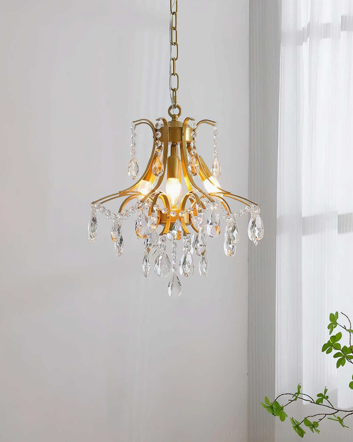 Sculptural gold chandelier with flowing curves inspired by natural wisteria plant form cascading light