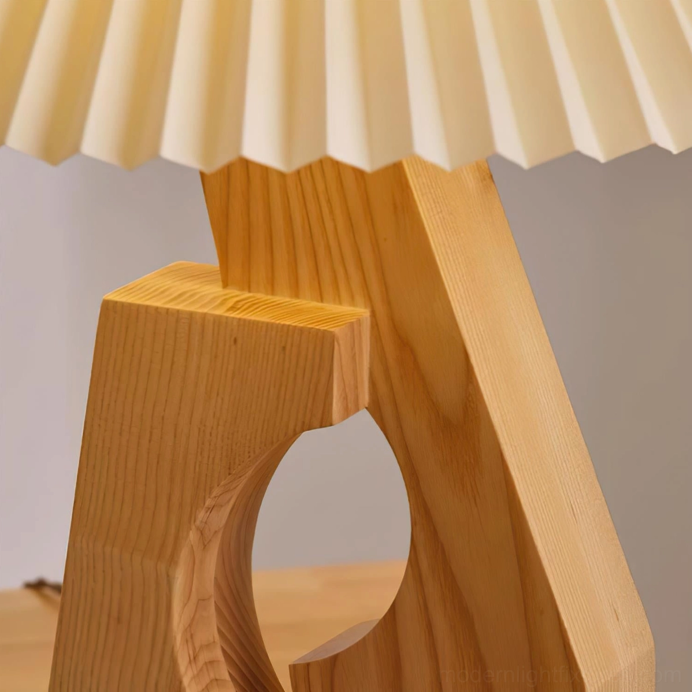 Pleated table lamp showcasing sculptural wood base design, minimalist modern home lighting fixture
