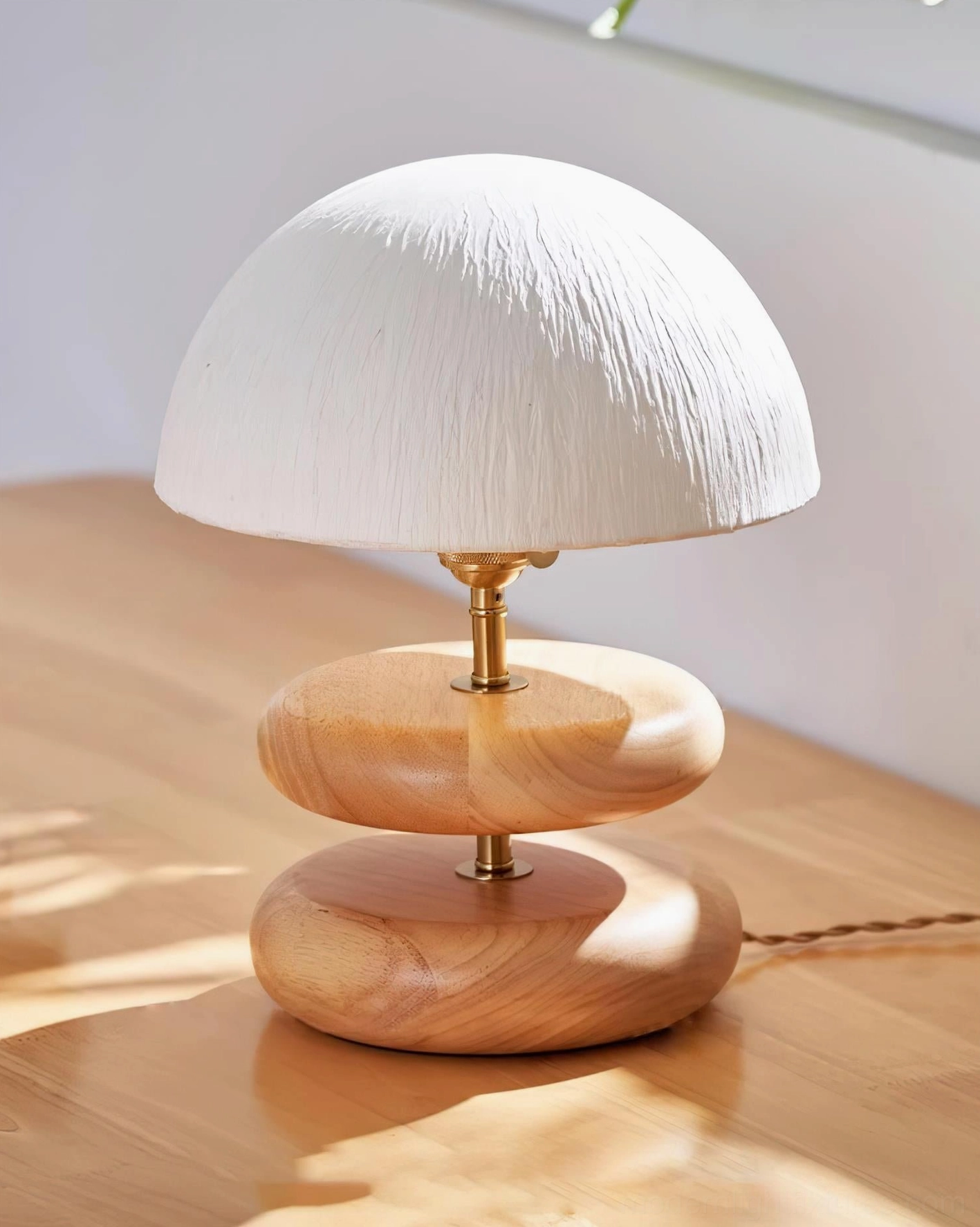 Sculptural stacked wood ring table lamp minimalist design brass accents diffused warm light fixture