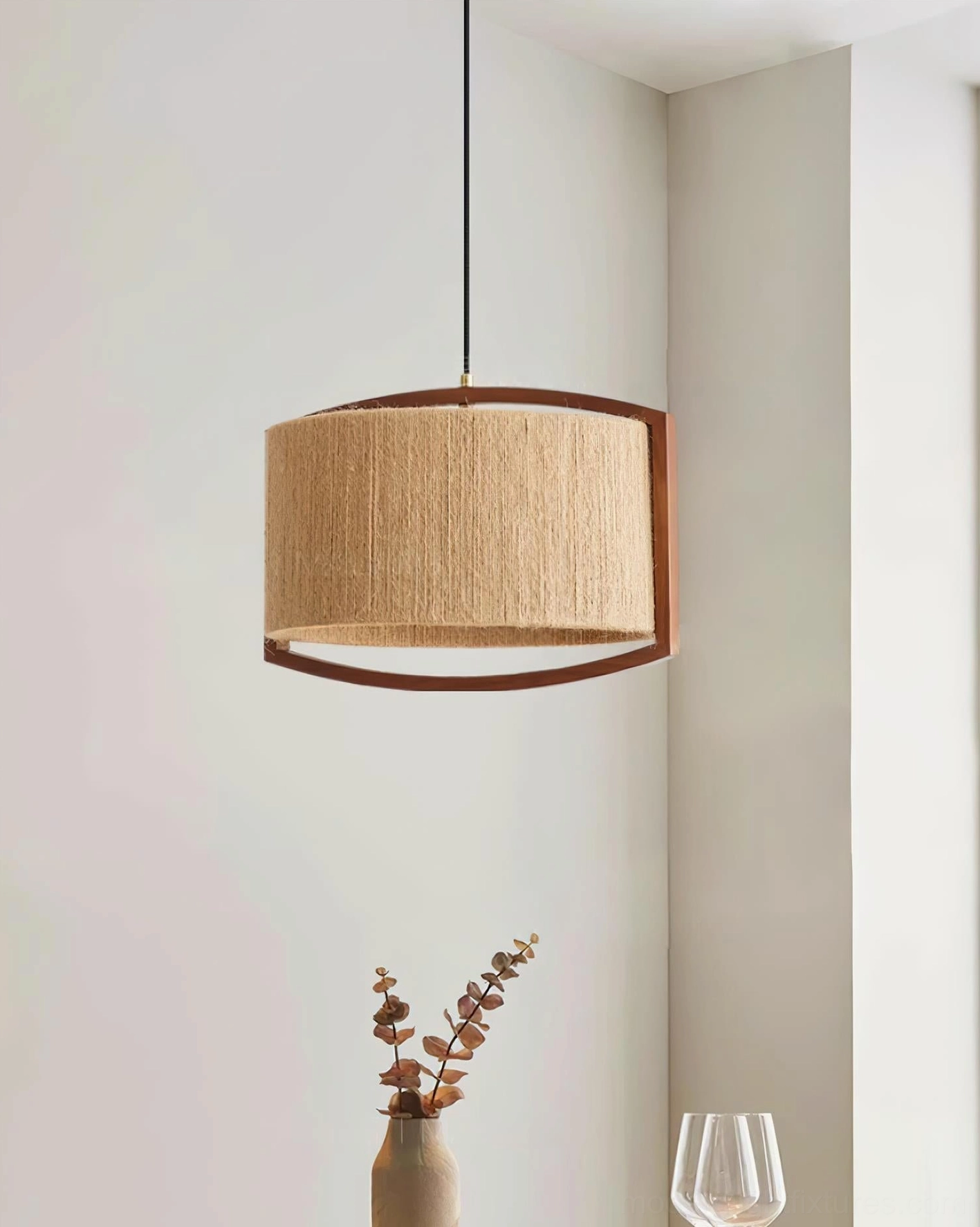 Handcrafted woven pendant lamp with half-circle walnut wood frame in corner setting, three-quarter angle