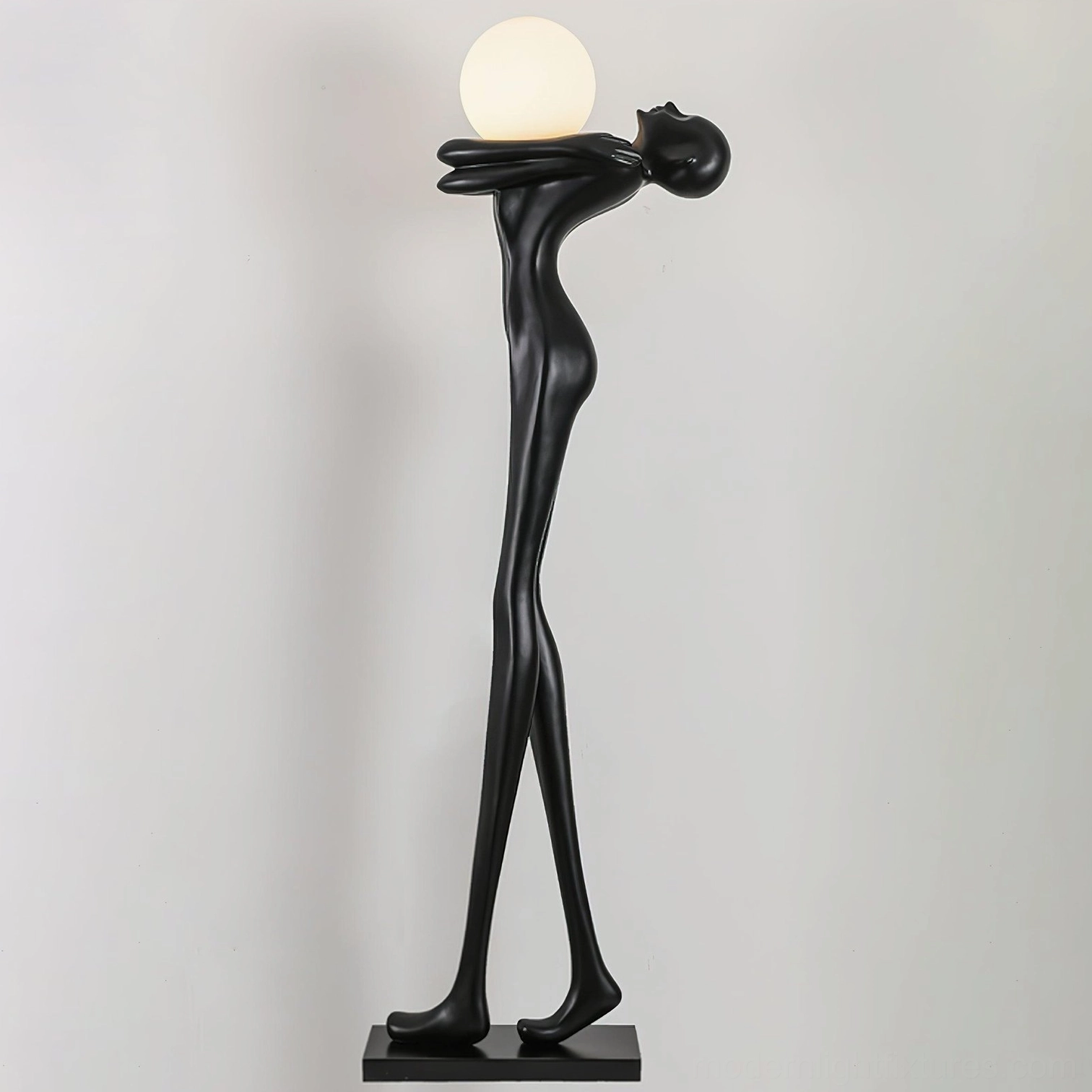 Contemporary human form floor lamp with soft frosted glass diffuser, direct front view, minimalist black resin body
