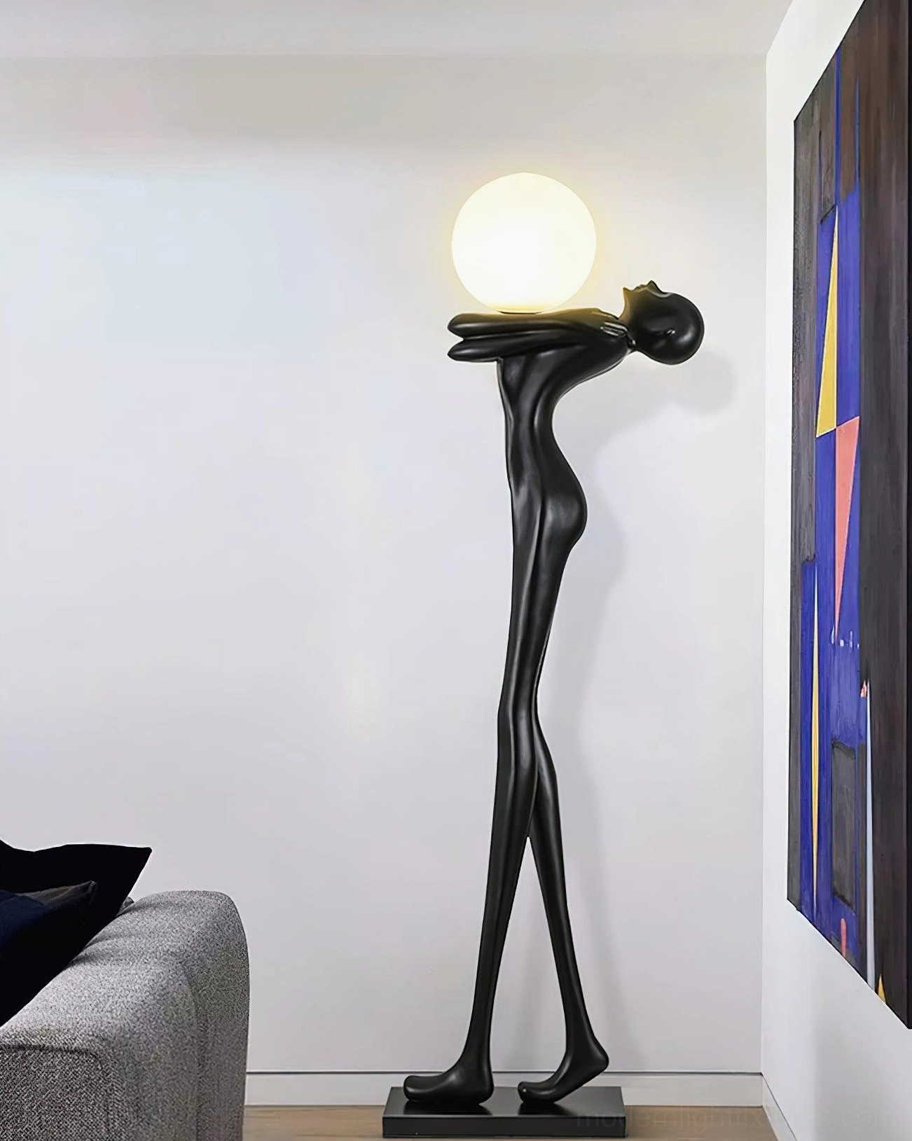 Black matte resin sculpture floor lamp in modern living room, frosted glass globe lit, artistic home decor