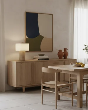 Modern travertine table lamp displayed on wooden sideboard in contemporary dining room with warm ambient lighting and interior decor