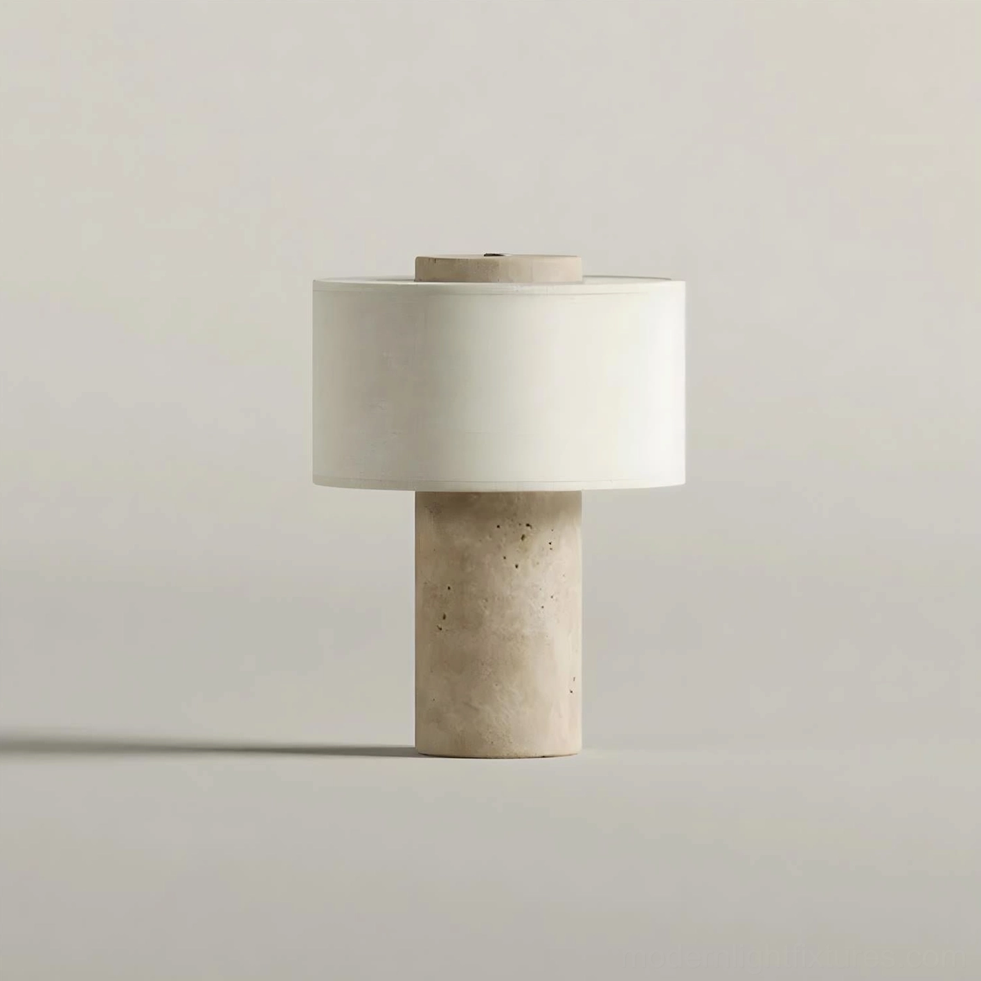 Sediment travertine base table lamp three-quarter front view on white studio background showing cylindrical stone base design