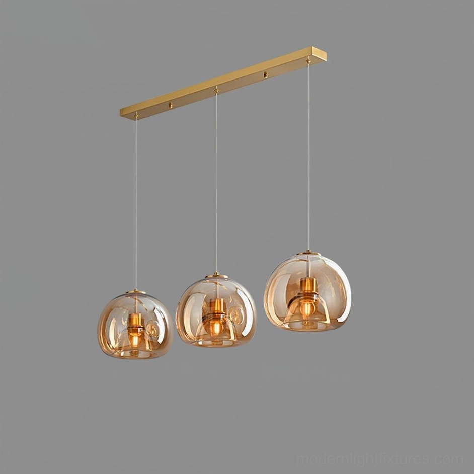 Sedona 3-head linear cognac smoked glass pendant light in modern dining room