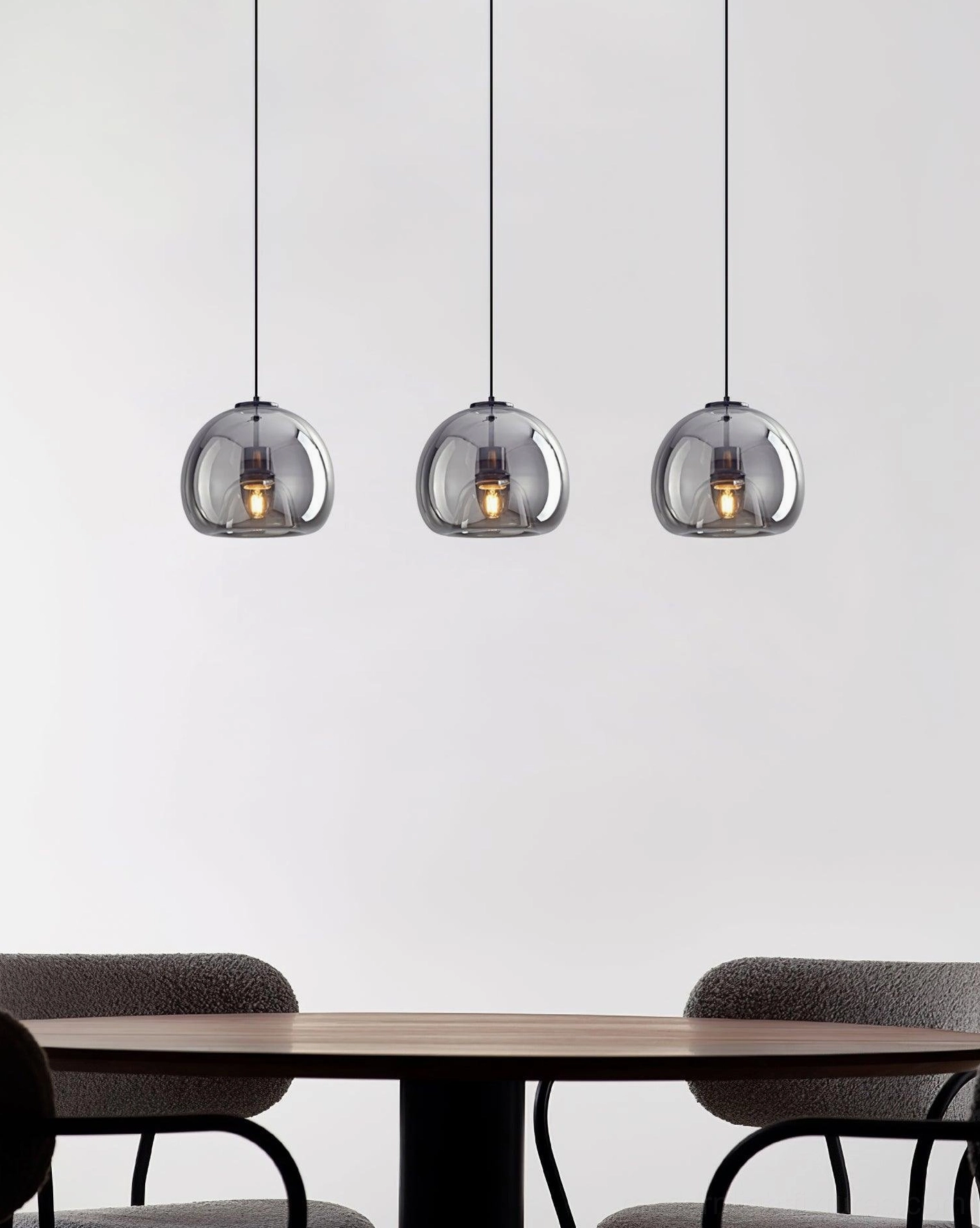 Sedona 3-head pendant light installation above wooden dining table with upholstered chairs, modern dining room