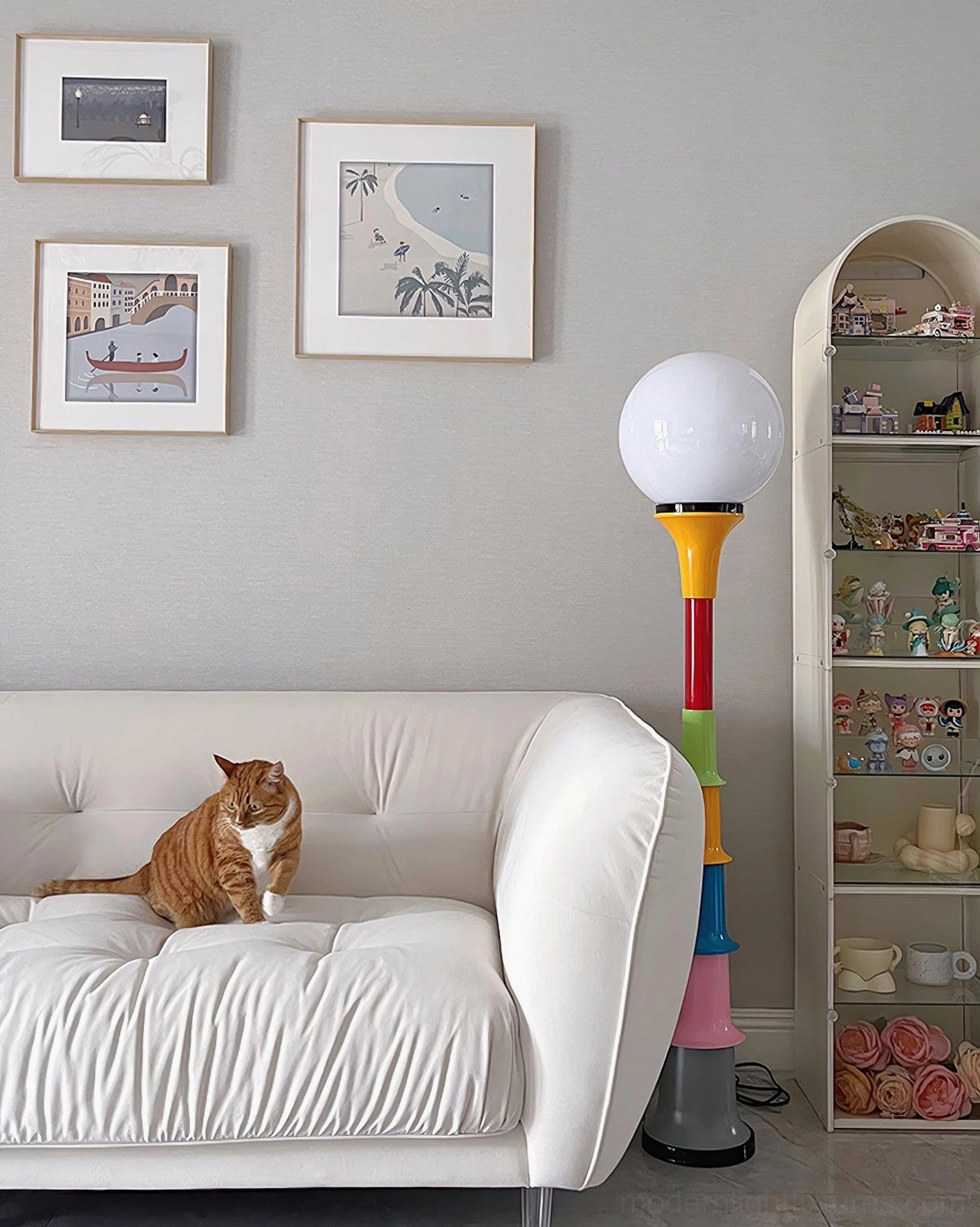 Colorful stacked floor lamp illuminated in Nordic-style living room with white sofa and display shelf