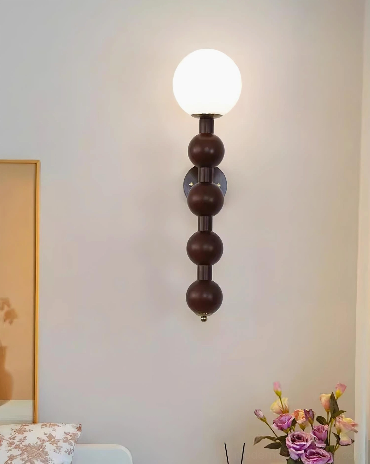 Selene beaded globe wall lamp mounted in feature wall lighting installation