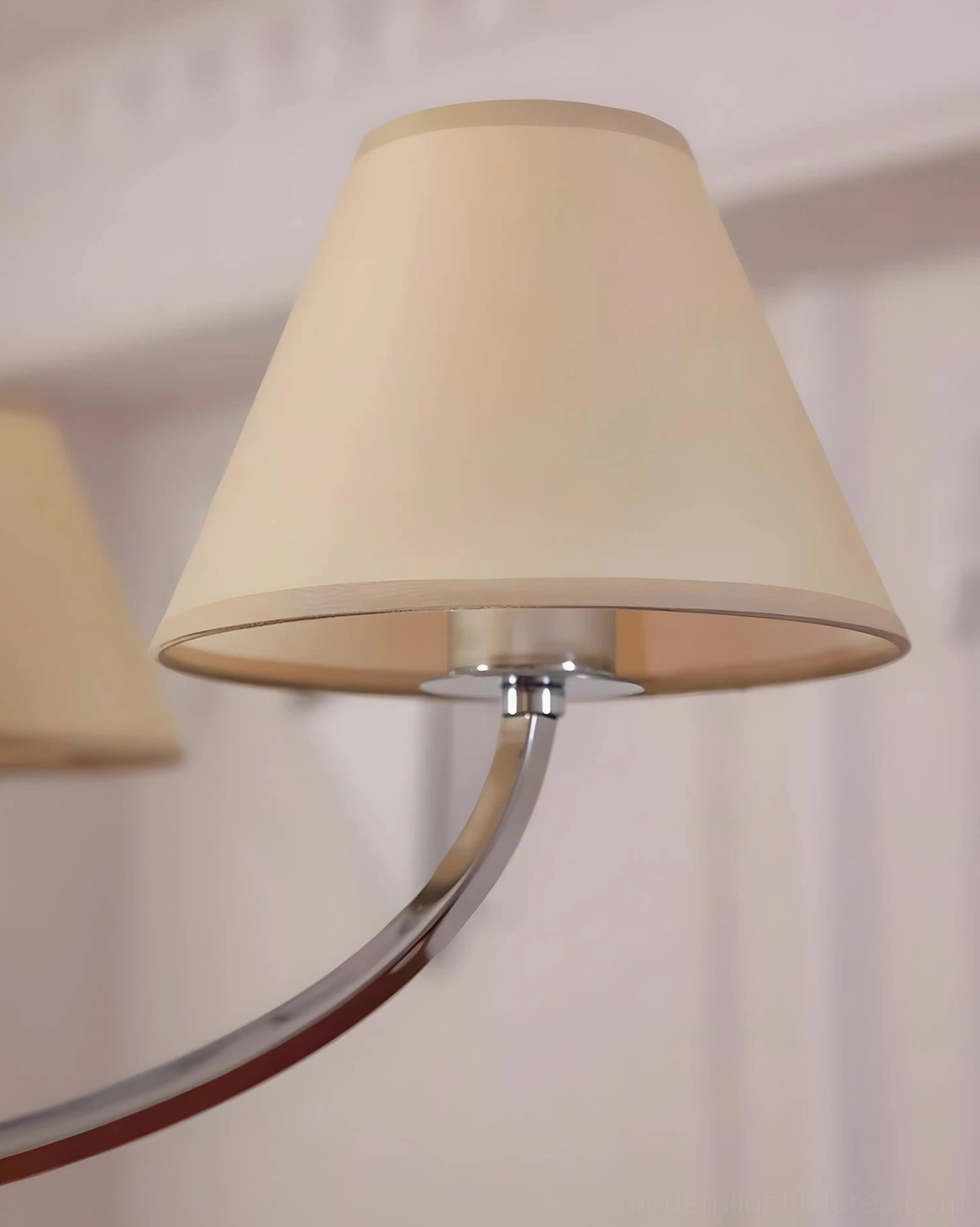 Contemporary curved arm chandelier in sophisticated mid-century modern interior with quality furnishings and warm ambient lighting