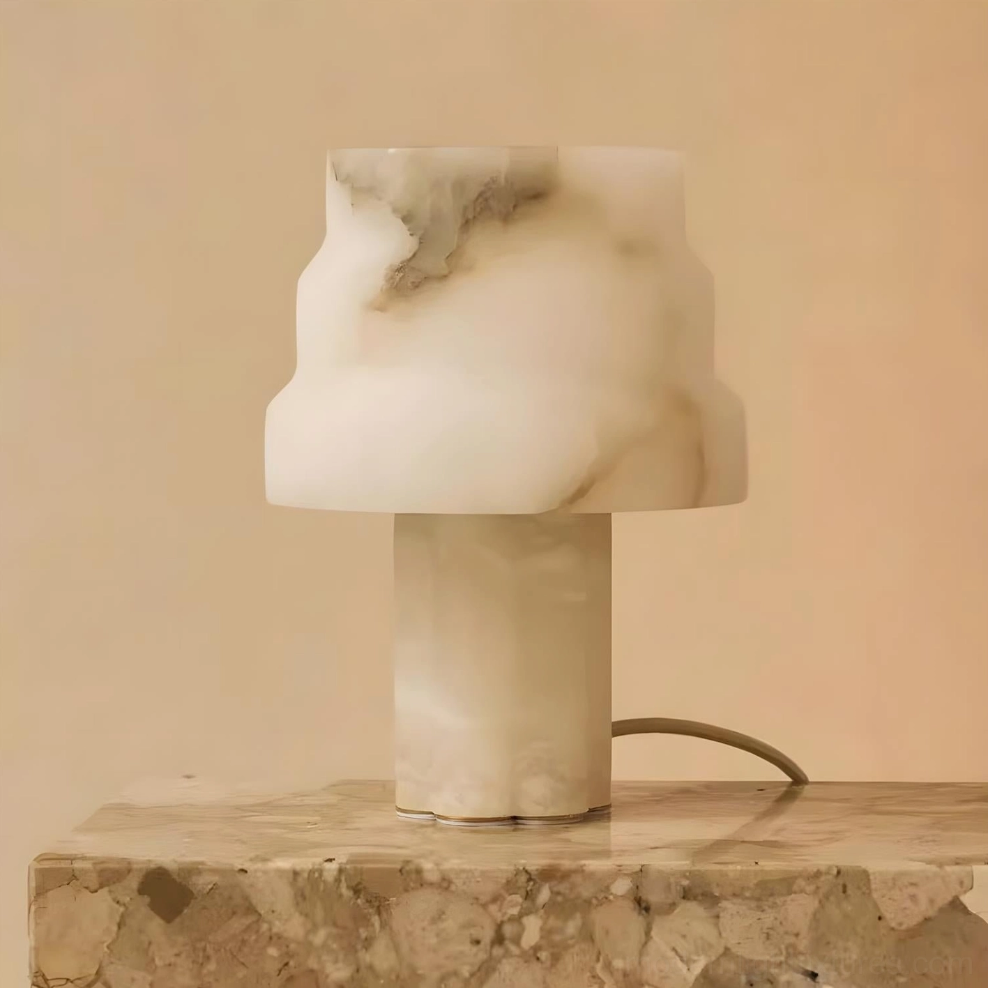 Selmora alabaster table lamp three-quarter view on luxury home countertop with exposed power cord and rough stone surface