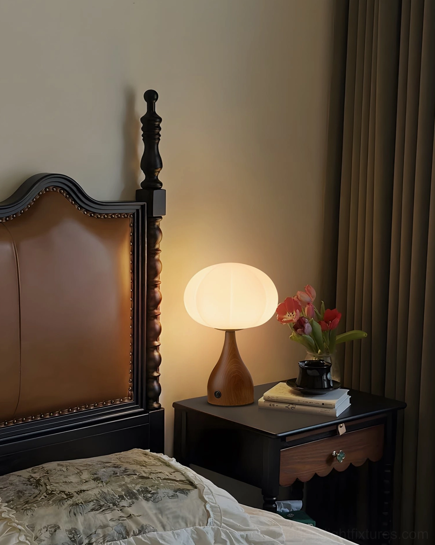 Vintage cottage bedroom lamp with tapered brown wood base and warm diffused lighting on leather headboard