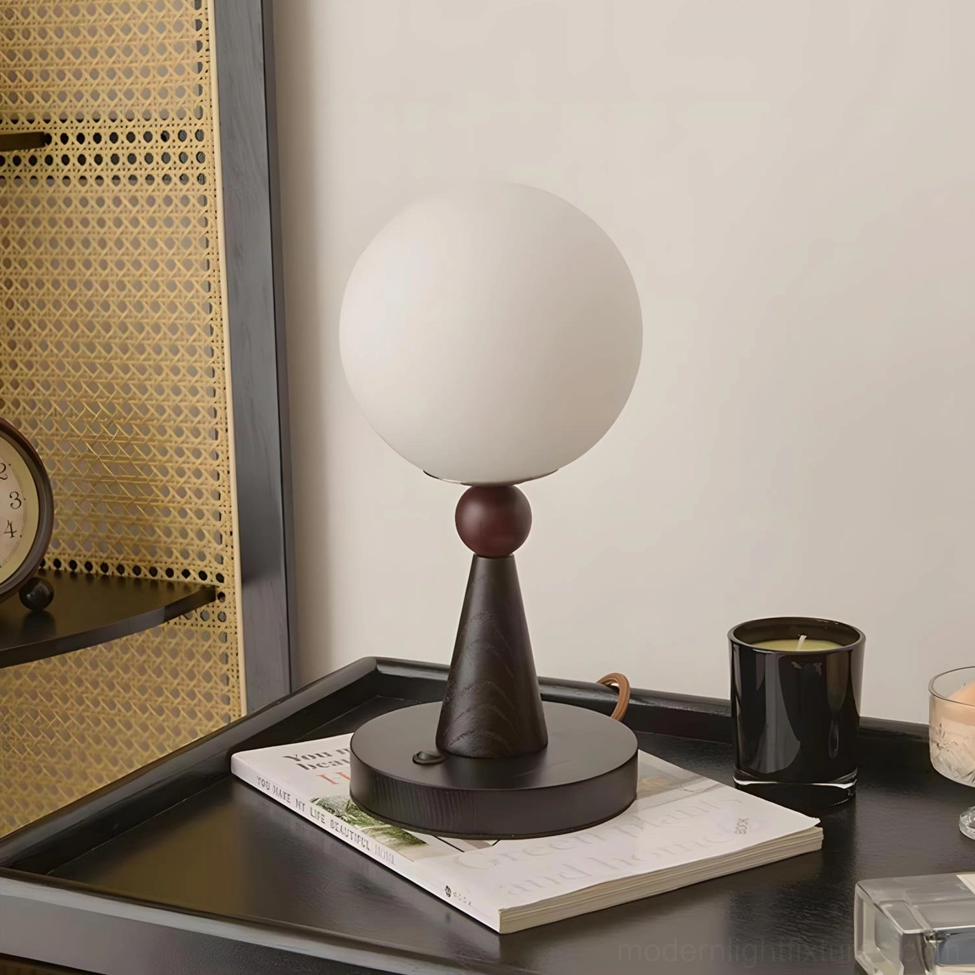 Seluna sculptural table lamp with spherical frosted glass shade and two-tone dark wood base on display