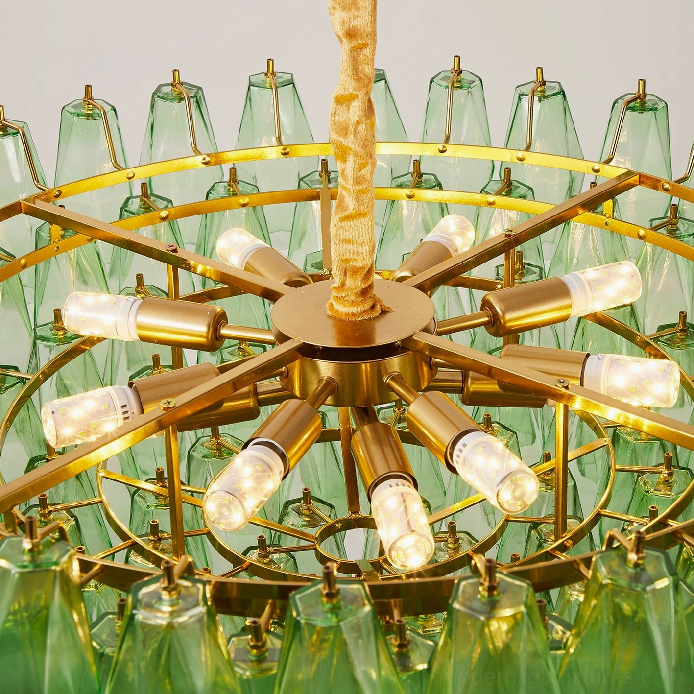 Selvara hand-blown glass tiered chandelier styled in contemporary home decor setting with botanical accents