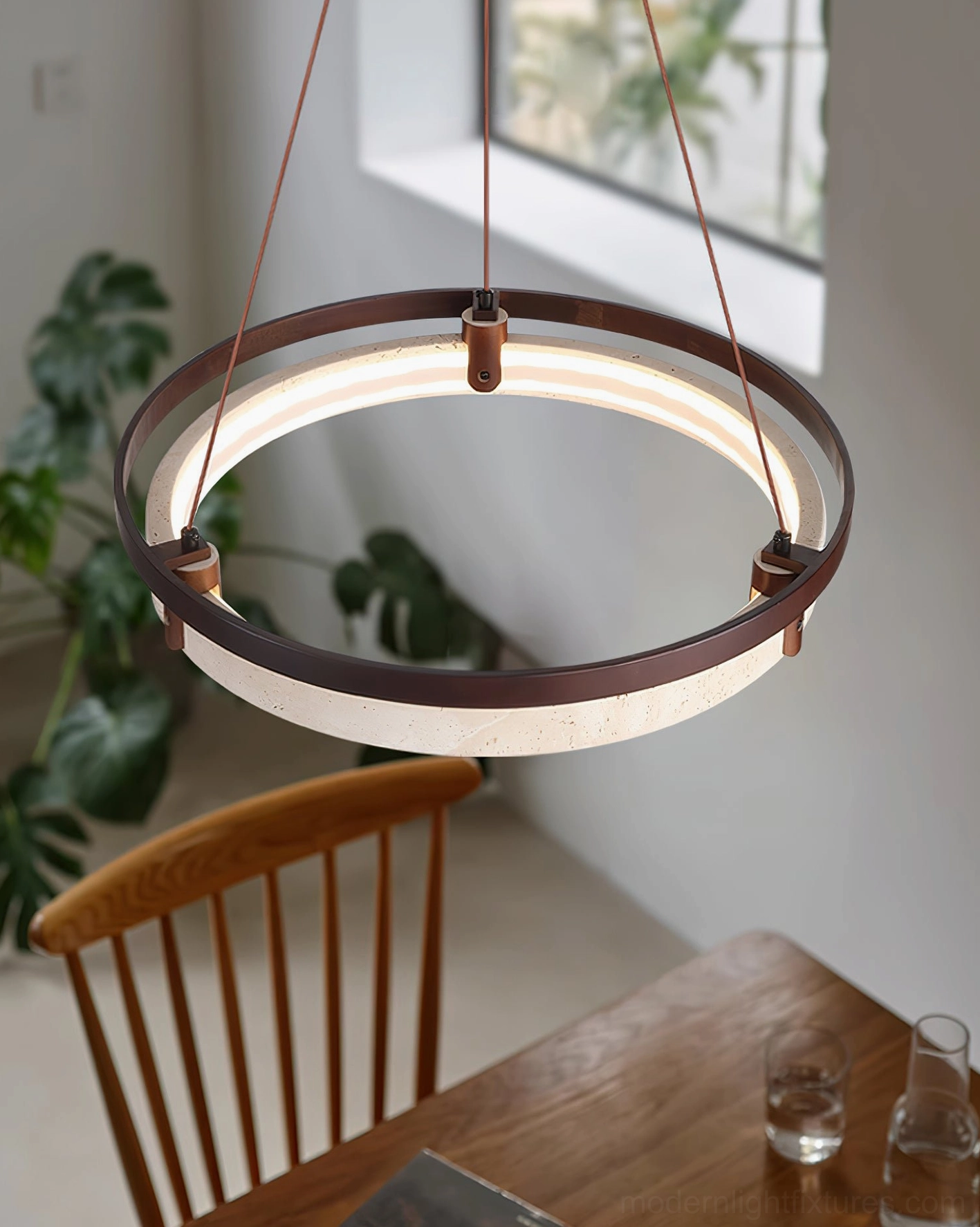 Selvino chandelier installed above dining table angled view residential interior