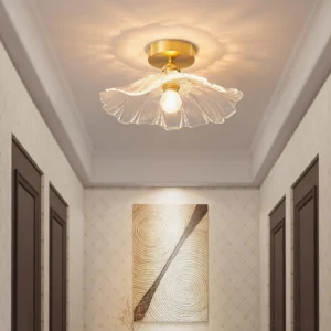 Ruffled glass semi-flush ceiling light installed in residential hallway with warm glowing illumination and brass hardware