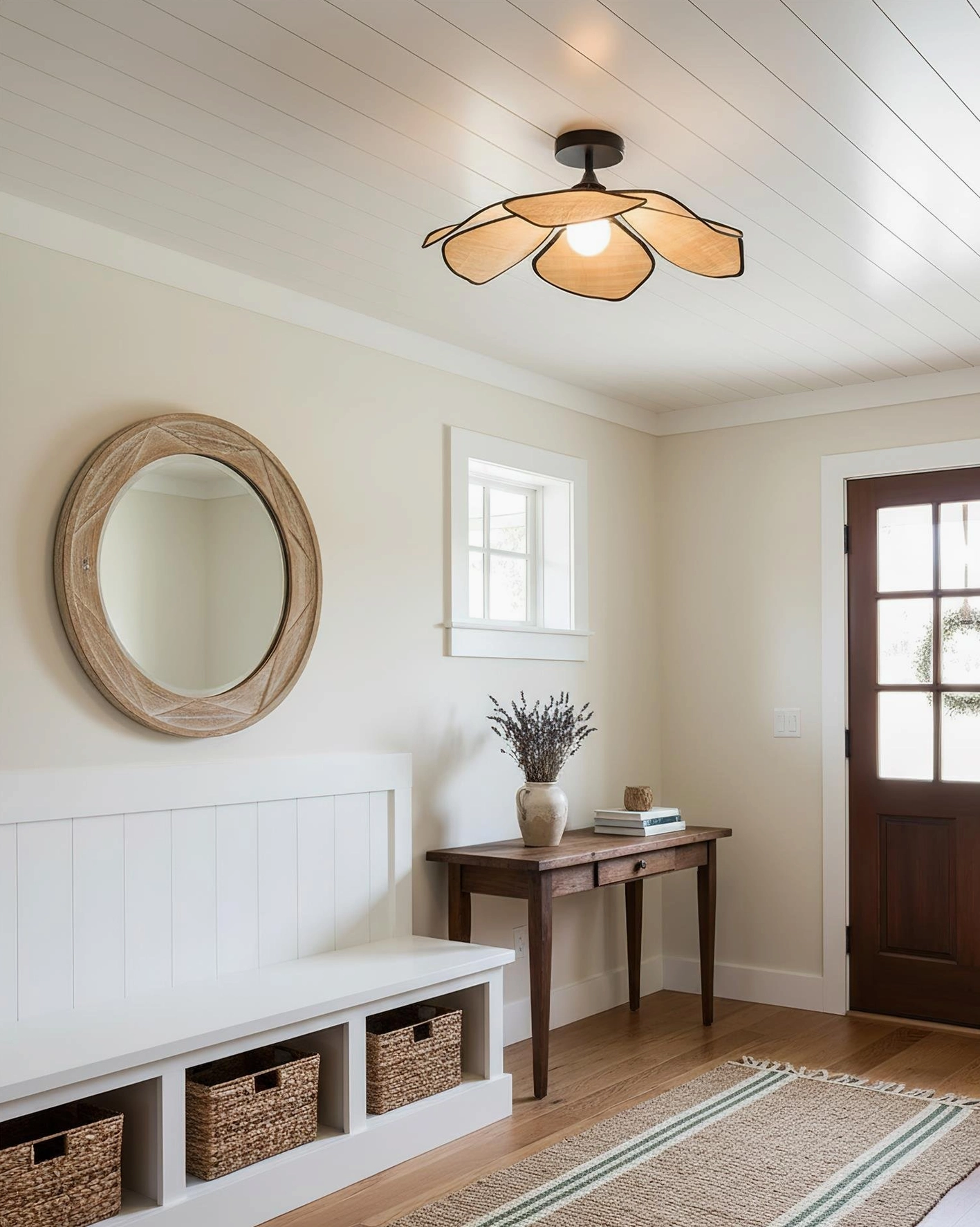 Illuminated raffia petal ceiling light in home entryway with shiplap ceiling, paired with round wall mirror and neutral bohemian decor