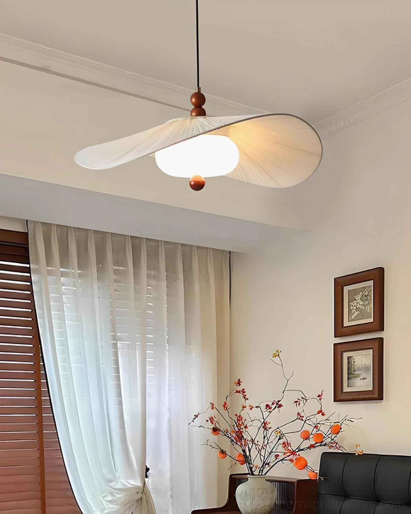 Serafina fabric pendant light in cozy living room with warm illumination casting soft ambient glow on pleated shade
