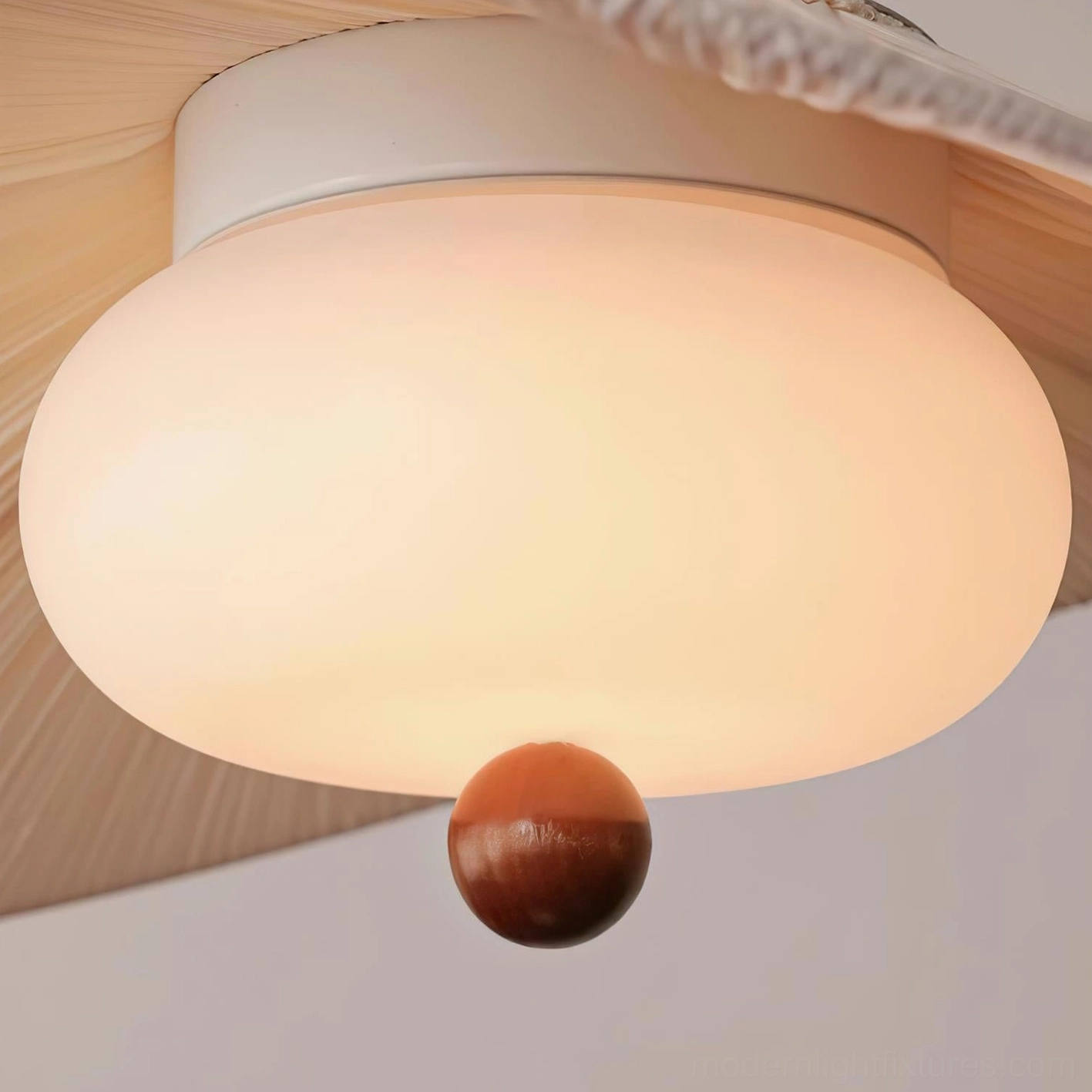 Serafina pendant light close-up bottom perspective illuminated showing pleated fabric shade wooden decorative ball warm light effect