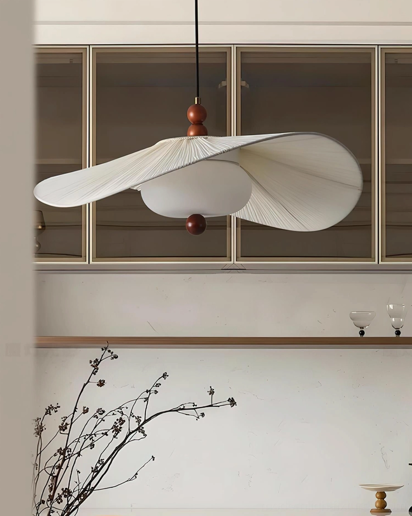 Serafina pendant light in modern minimalist kitchen dining space with walnut wood finial and off-white pleated shade design
