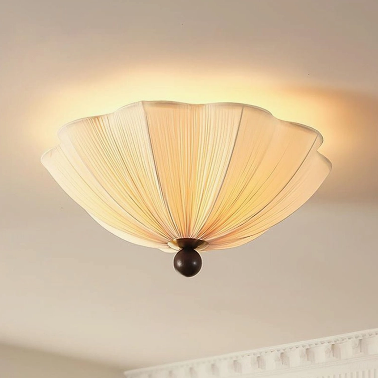 Seralyn modern ceiling light fixture three-quarter view highlighting radial pleated fabric texture, warm beige tone, and sculptural dark metal base