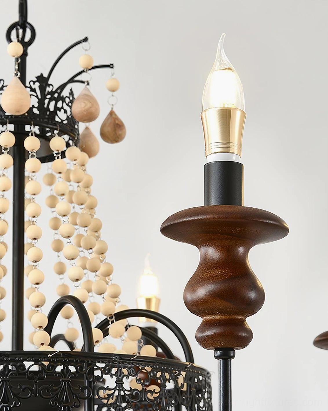 Seraphine black iron and walnut beaded chandelier in ambient warm candlelight showing atmospheric dining room application