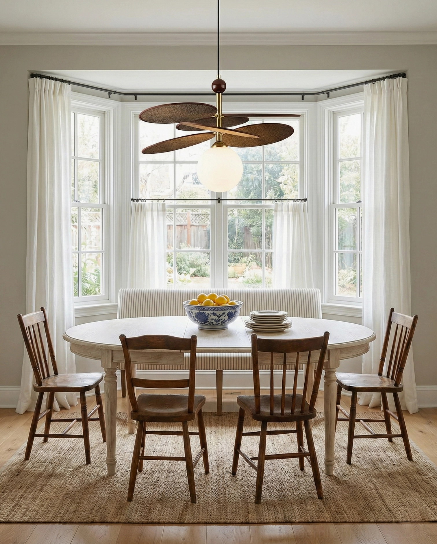 Front elevation view of Seraphis mid-century modern pendant light with glass globe and wooden blade accents