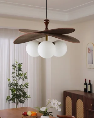Modern mid-century pendant light with three glass globes and wooden blade frame in dining room setting
