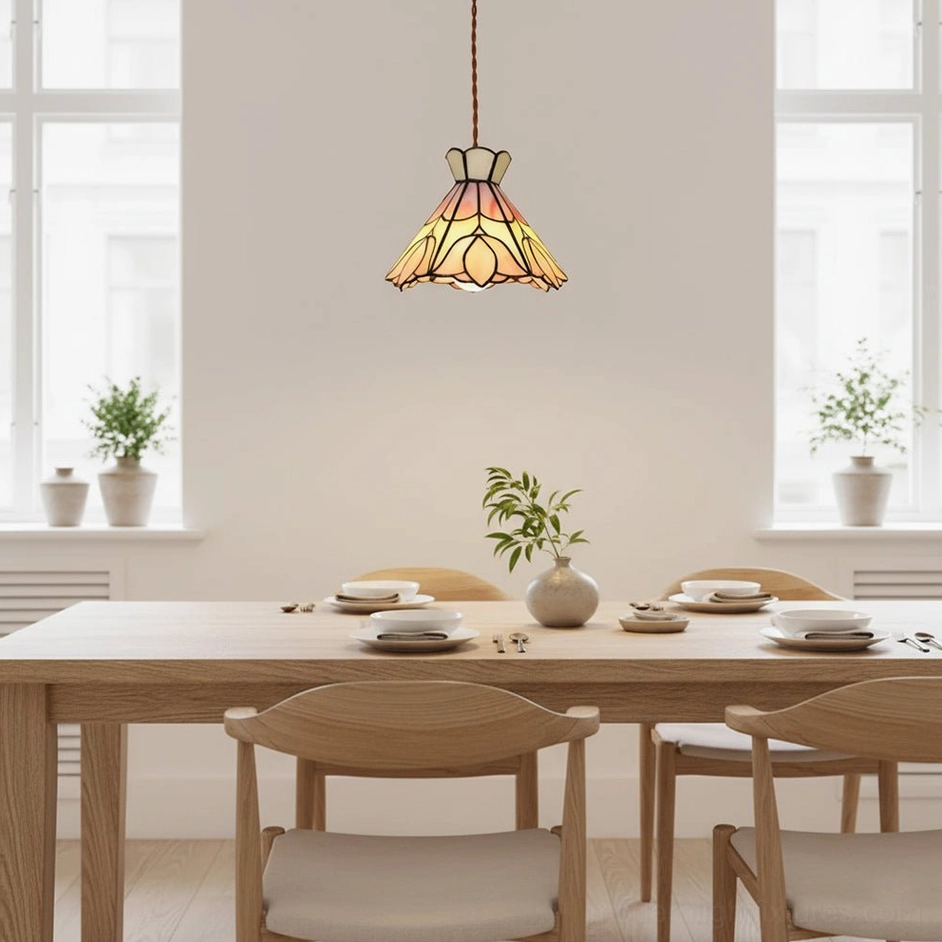 Serena stained glass pendant light above dining set in bright minimal interior, decorative brass braided cord