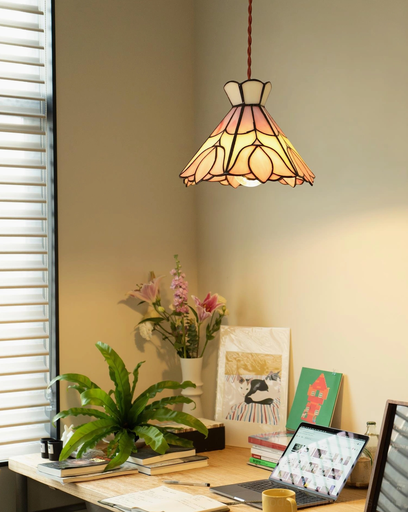 Serena stained glass pendant light hanging above home office desk workspace, decorative task lighting installation