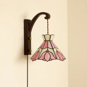 Tiffany plug-in wall lamp with curved brass bracket and pink cream stained glass - three-quarter angle