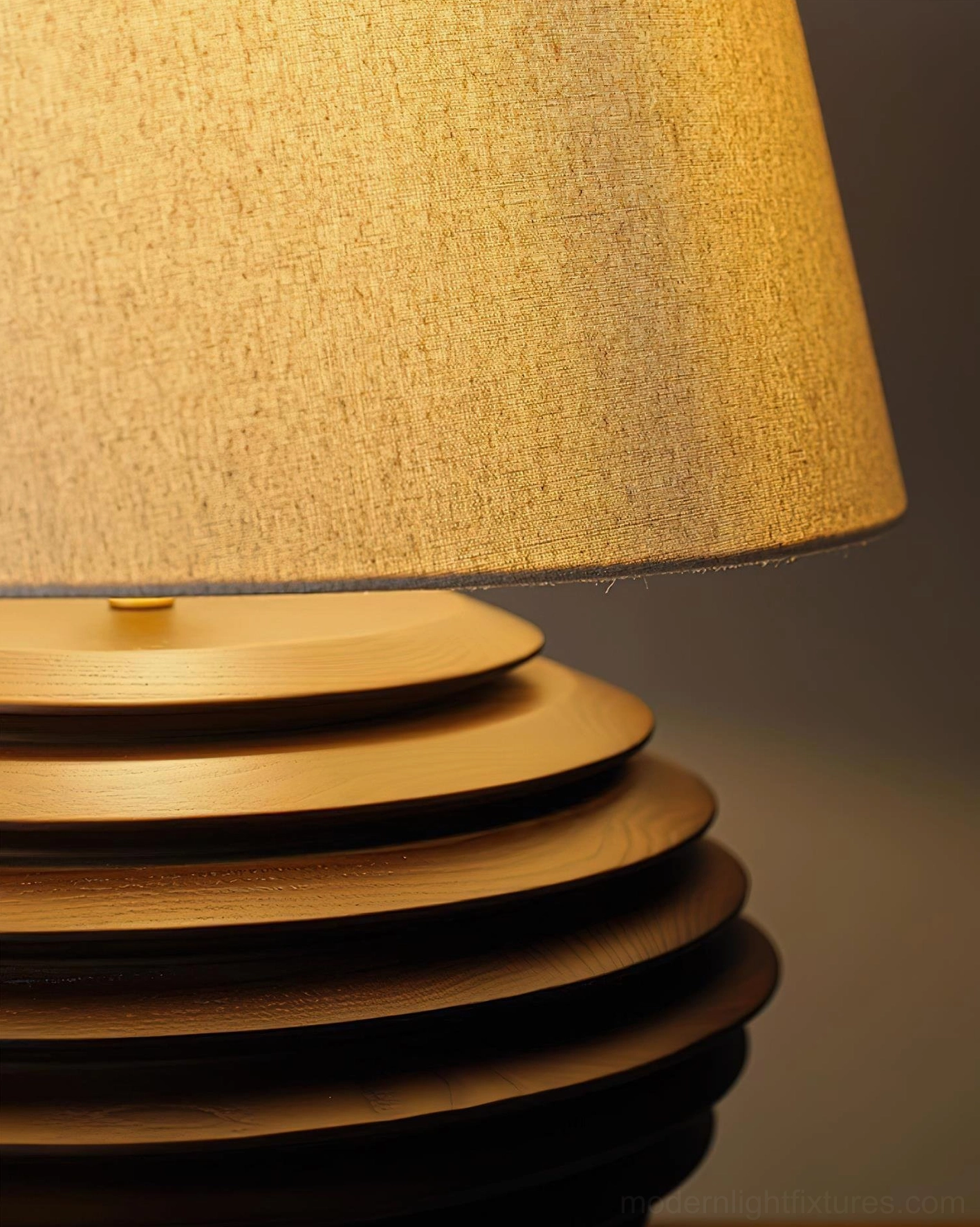 Serenity Strata table lamp side view in contemporary setting showing sculptural ribbed base and warm light diffusion through fabric shade
