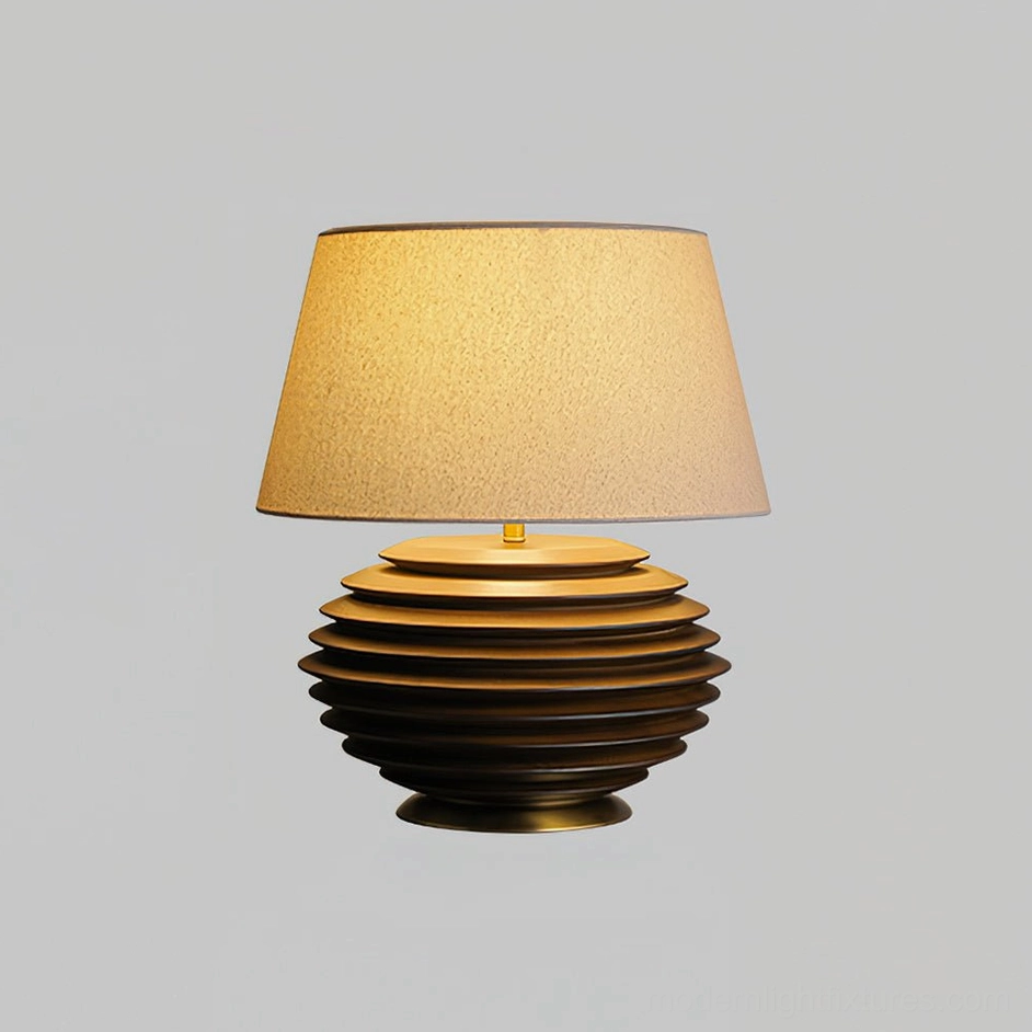 Serenity Strata table lamp walnut color finish on textured surface, warm lit shade creating intimate lighting atmosphere in bedroom