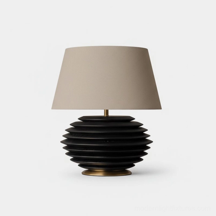 Serenity Strata table lamp with black ribbed ceramic base and beige tapered cotton-linen fabric shade on white studio background, modern minimalist design