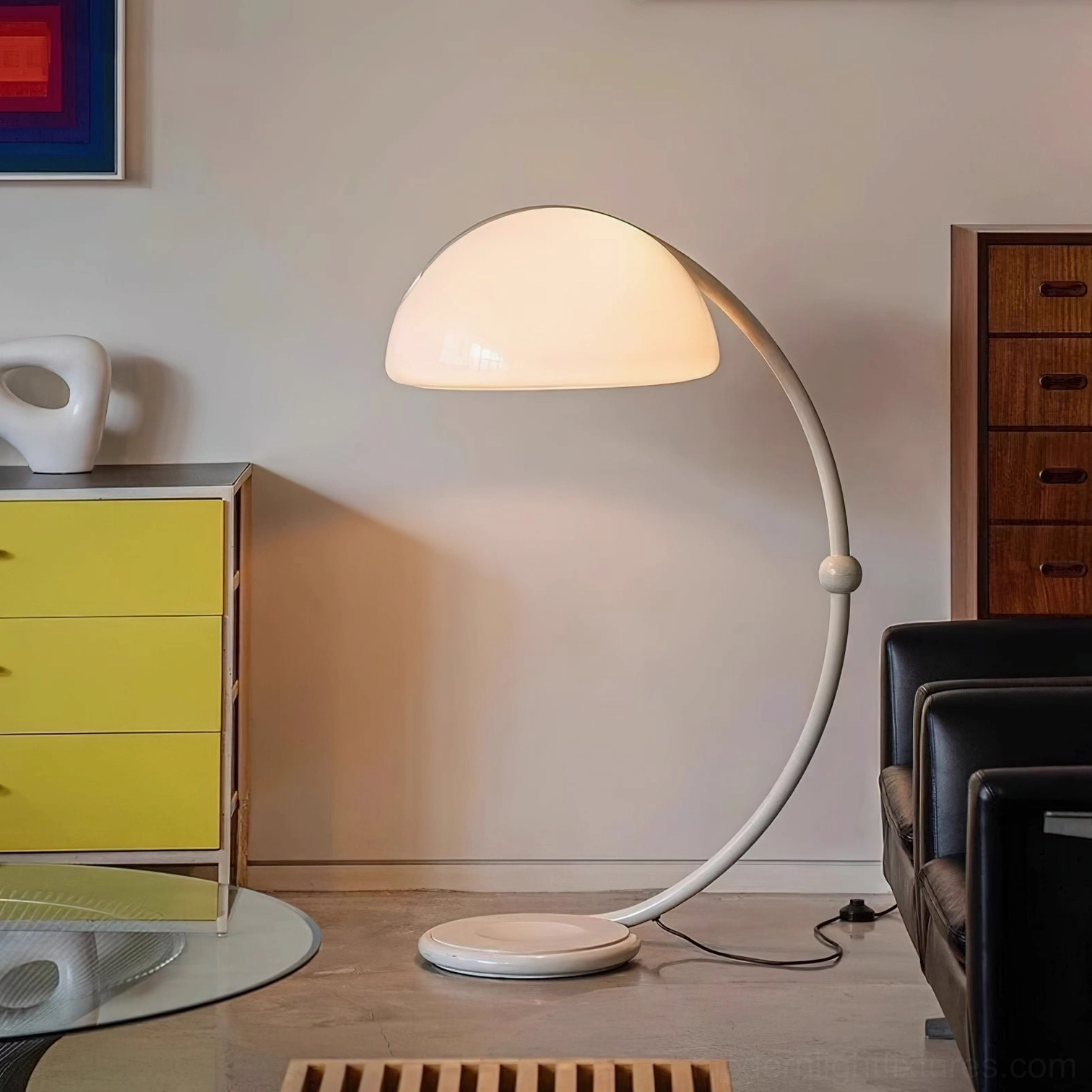 White Serpente rotating floor lamp in mid-century modern living room with yellow dresser and leather seating