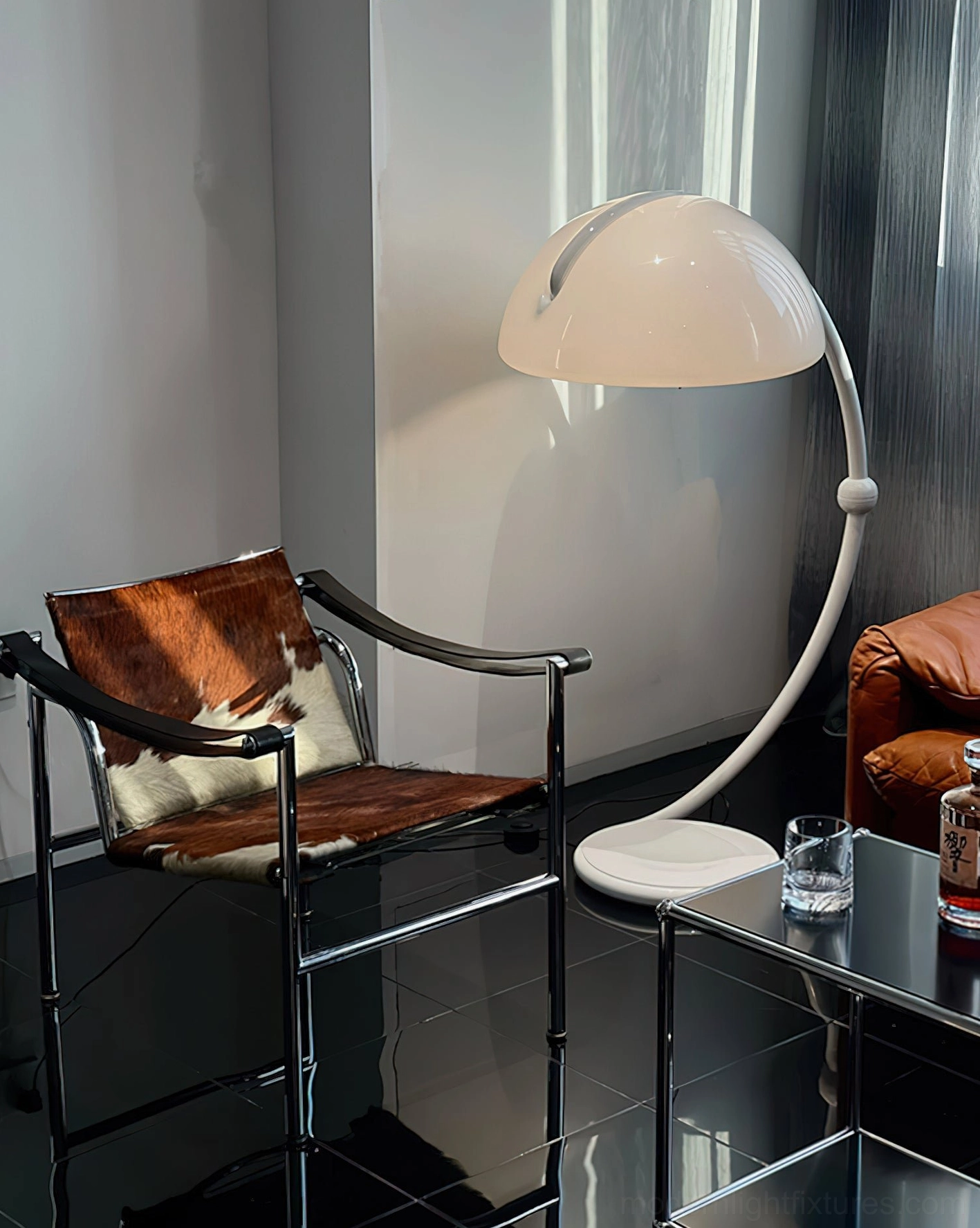 White Serpente rotating dome floor lamp in articulated position demonstrating flexibility