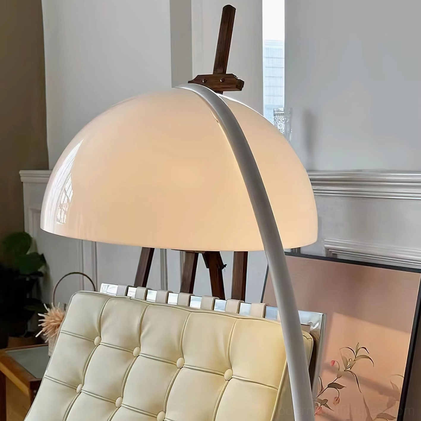 White Serpente rotating dome floor lamp illuminated showing light distribution and warm glow effect